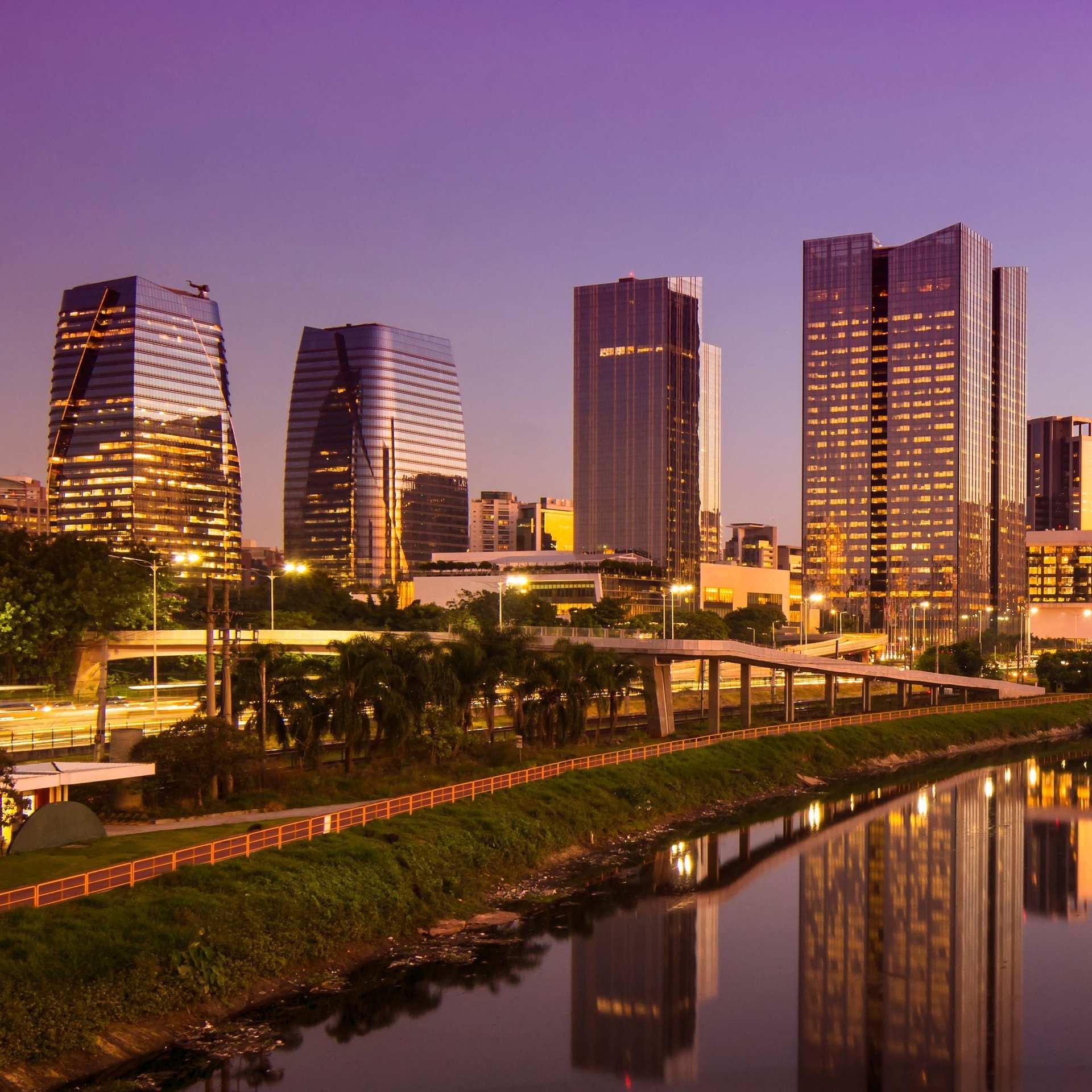 a woman sitting at a table using a laptop computer