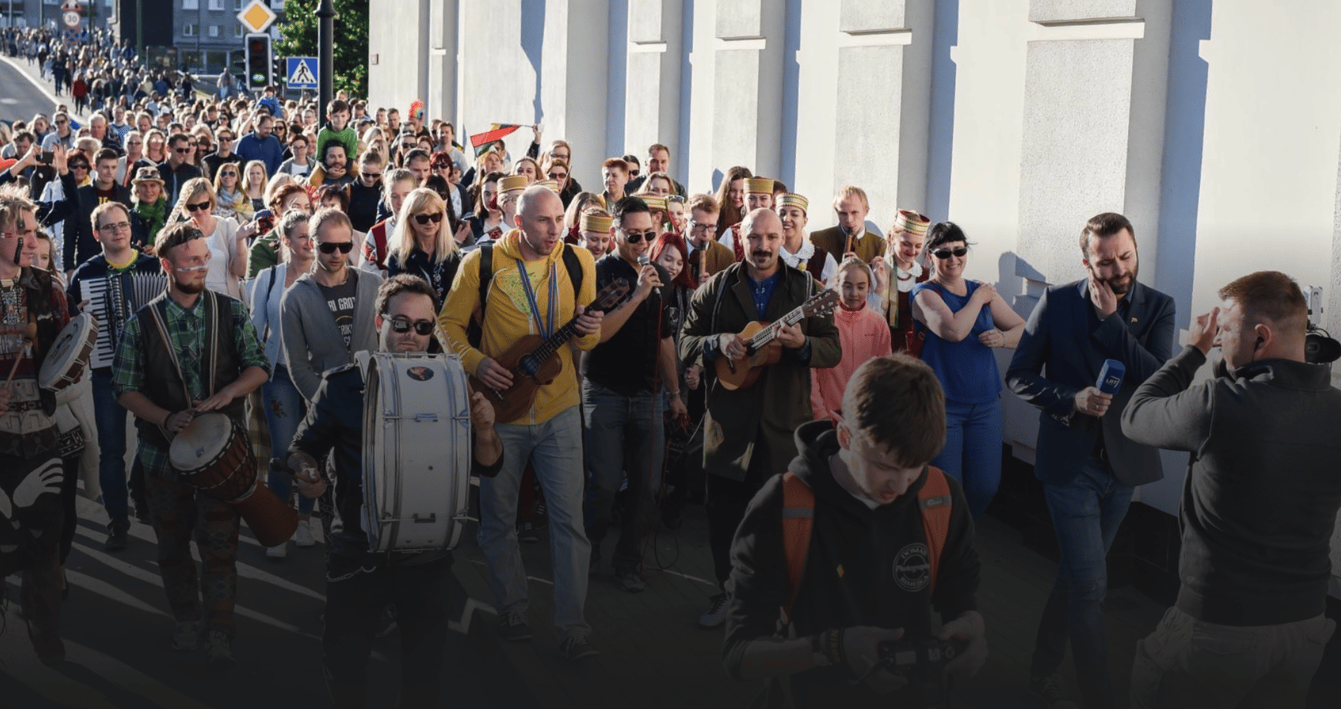 woman in white and brown dress standing on green grass during night time