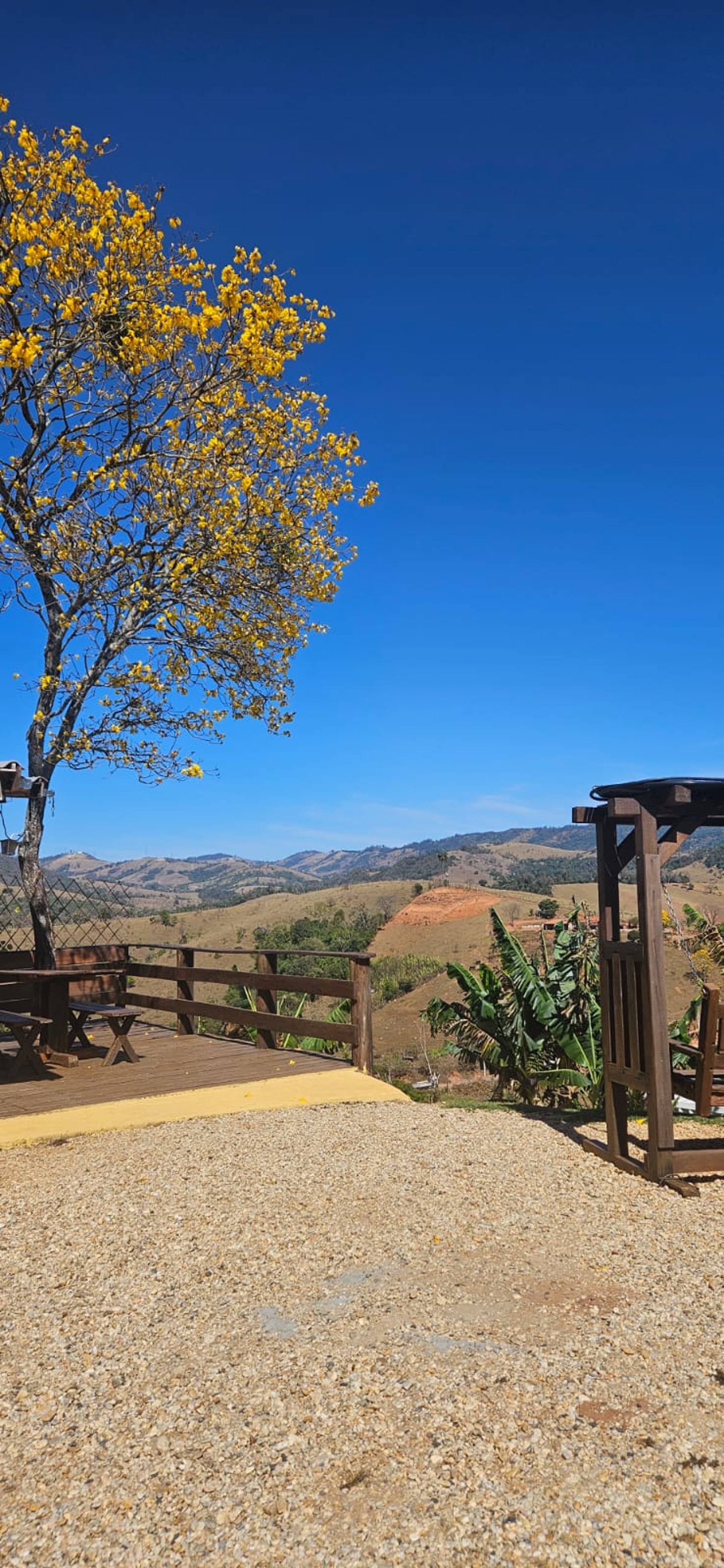 man in black and white shirt and blue denim jeans sitting on rock formation during daytime