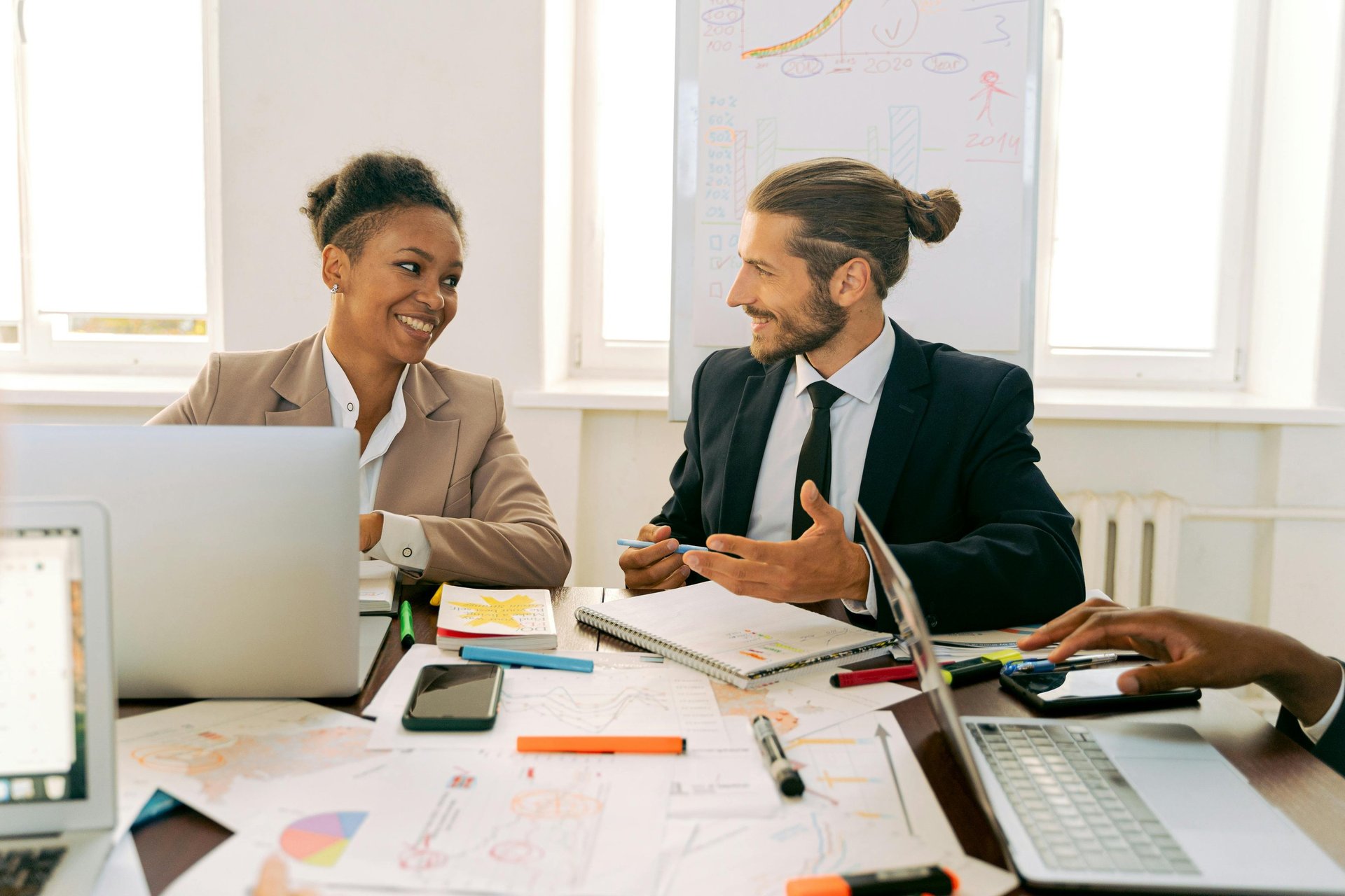 Three co-workers sitting together in the office with Surface laptop on the table