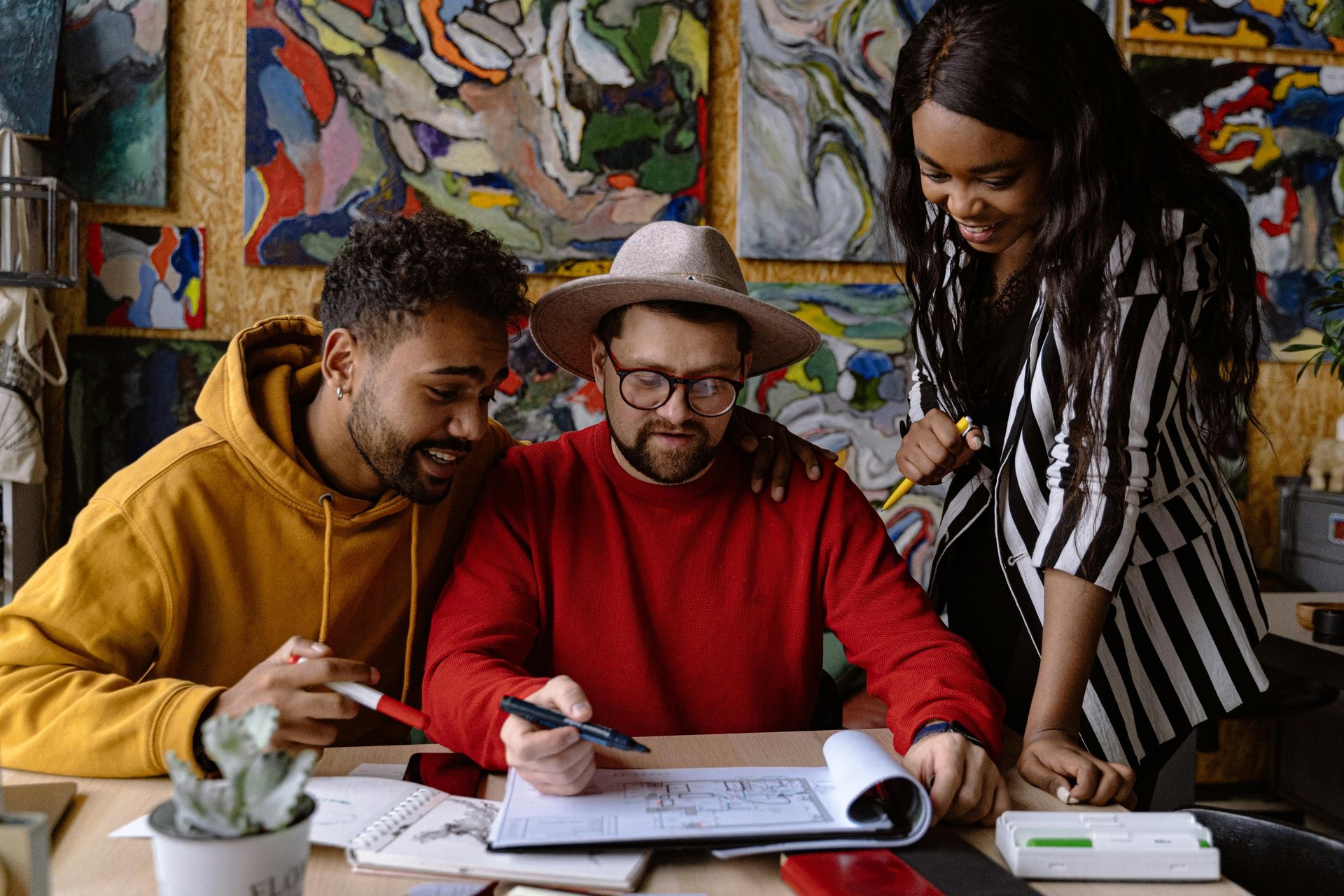 Three co-workers sitting together in the office with Surface laptop on the table
