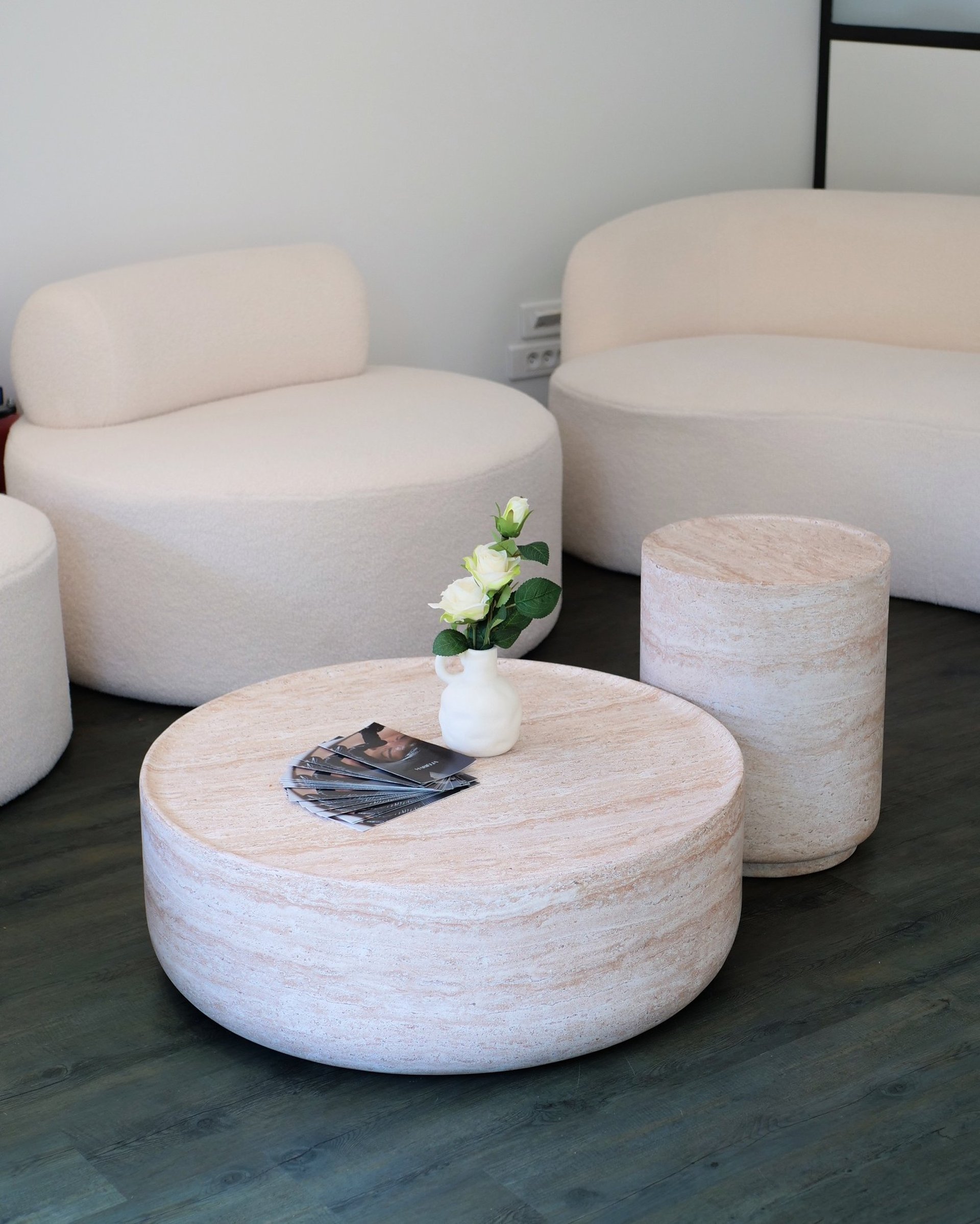 a white candle sitting on top of a white box