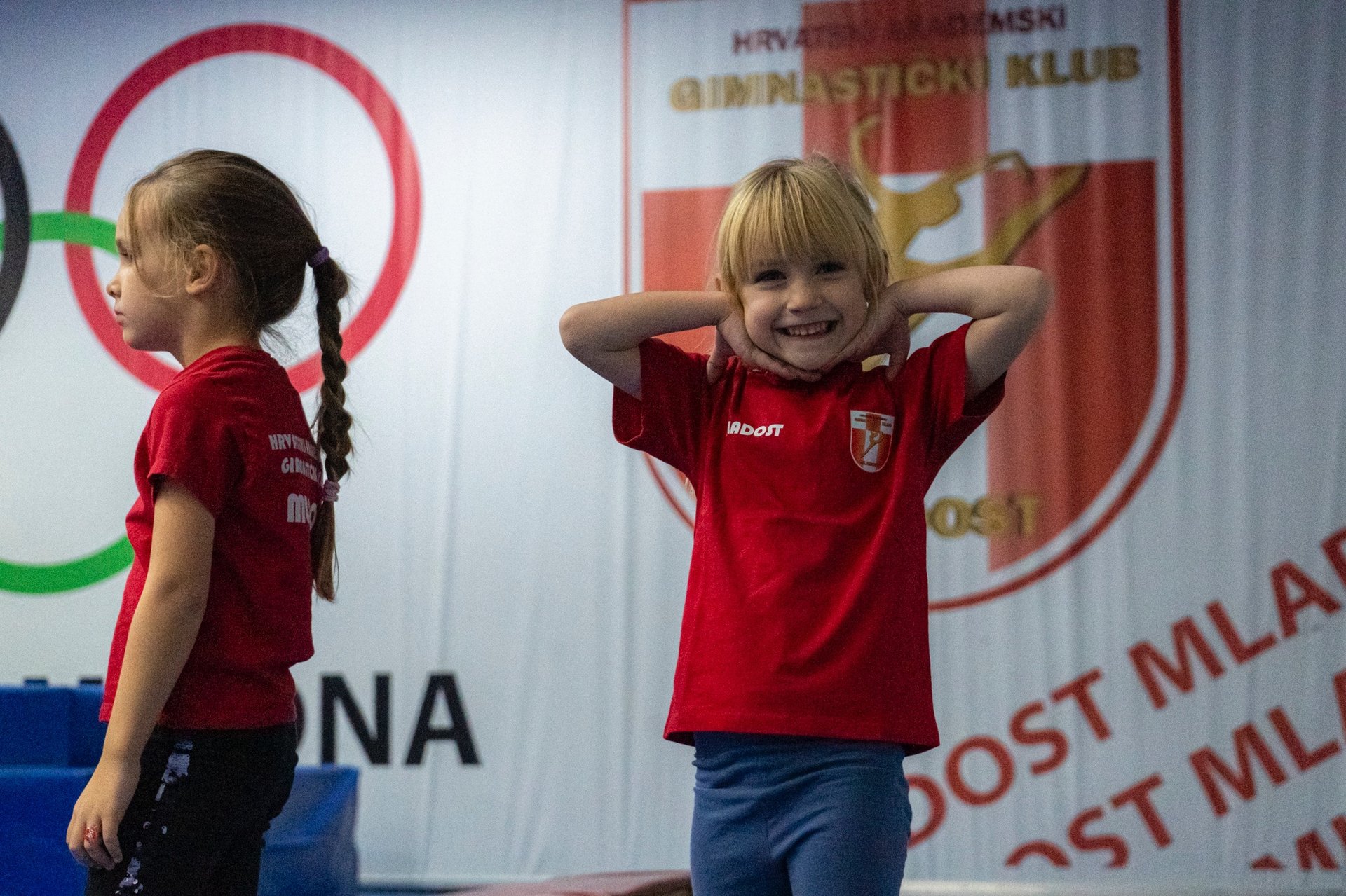 a group of girls sitting on a mat