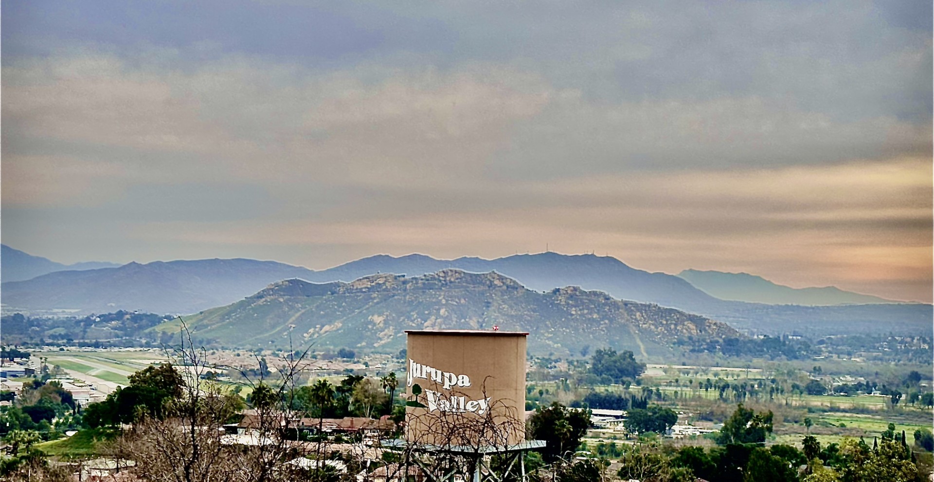 teal Volkswagen Beetle parked near brown house