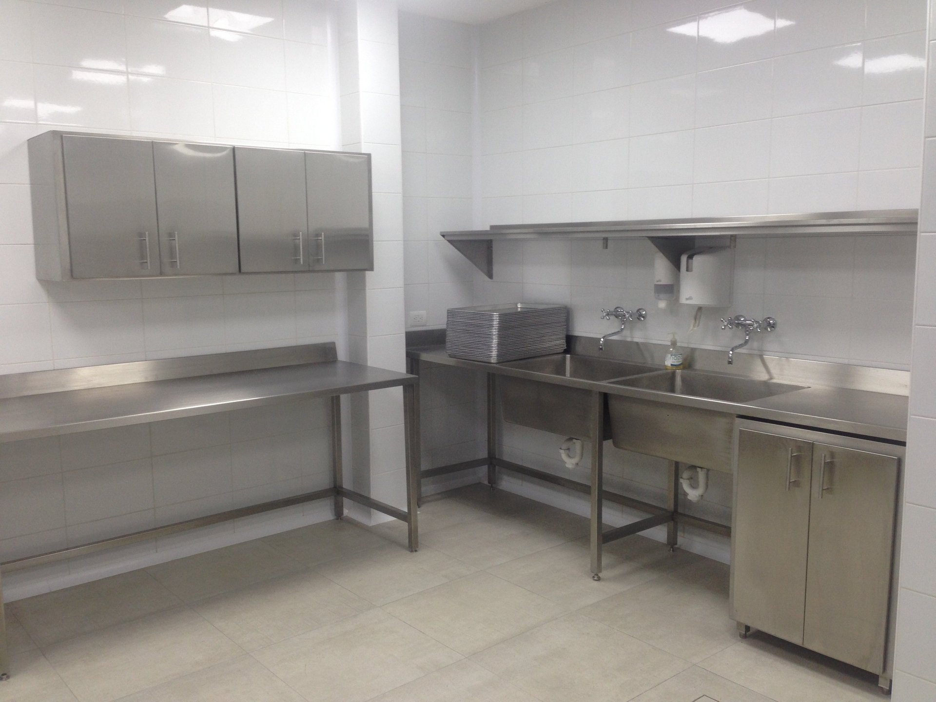 A kitchen with a stove top oven next to a washer and dryer