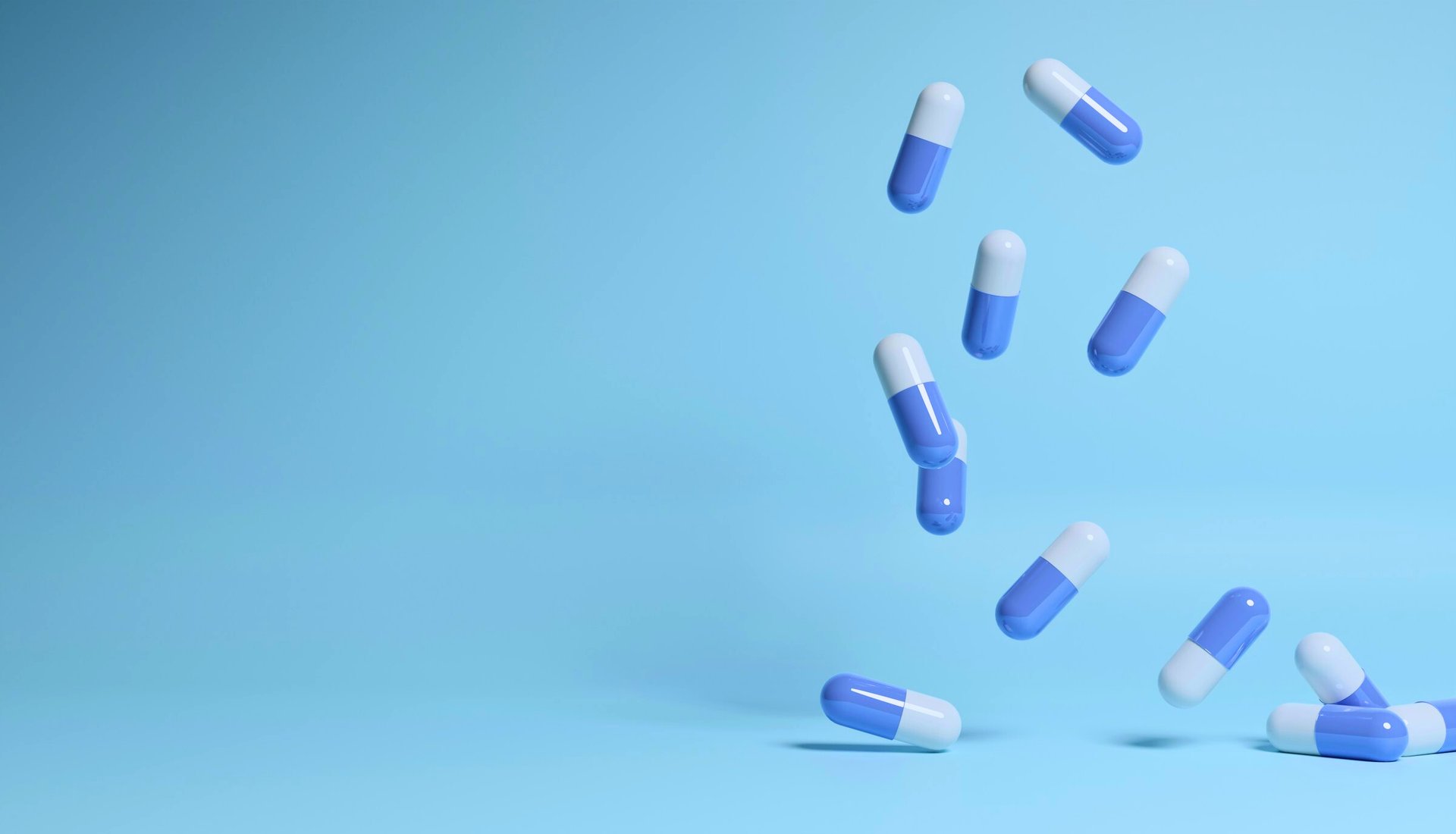 a group of pills falling into the air