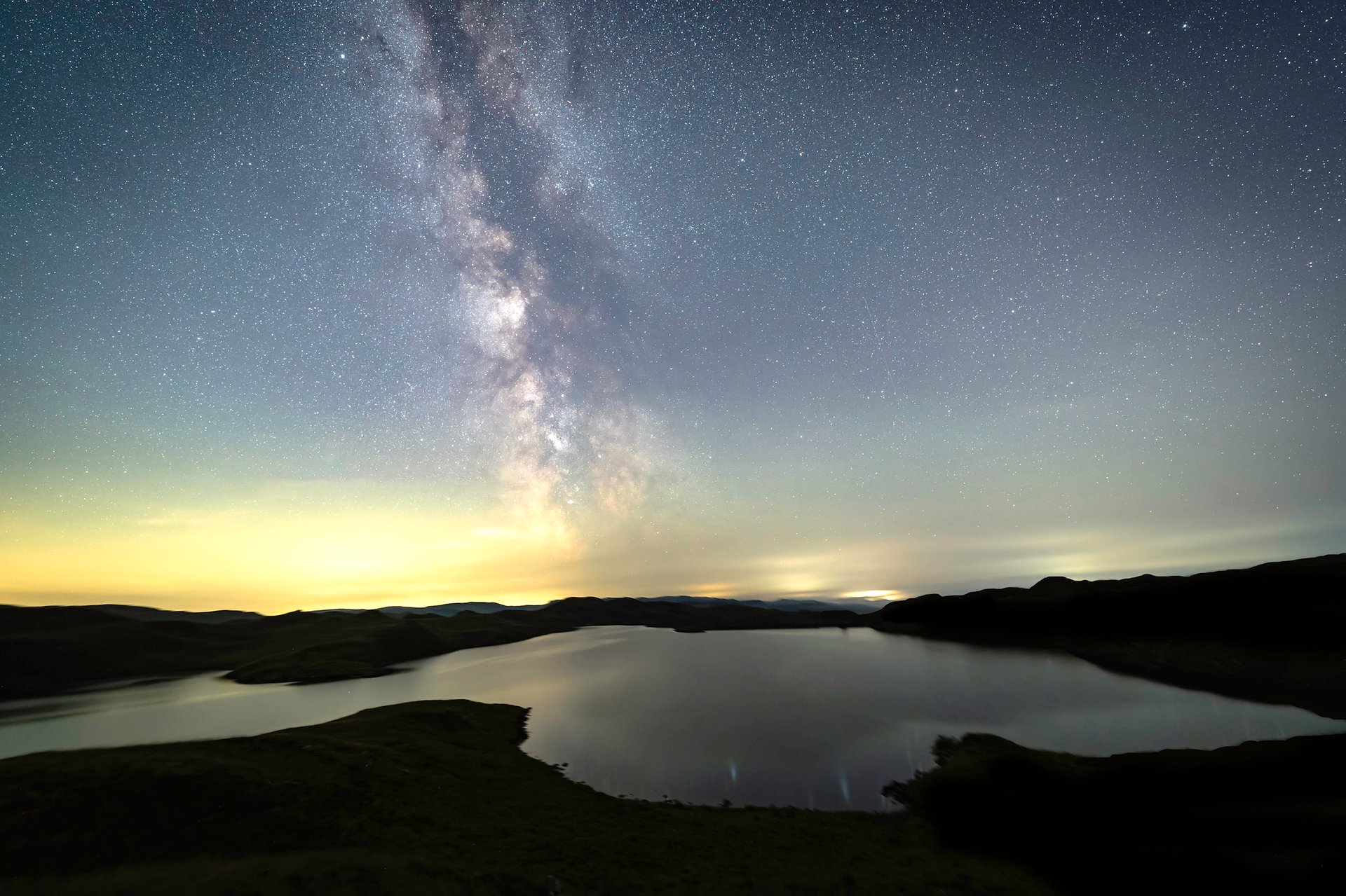 a view of the barns with pond in the foreground