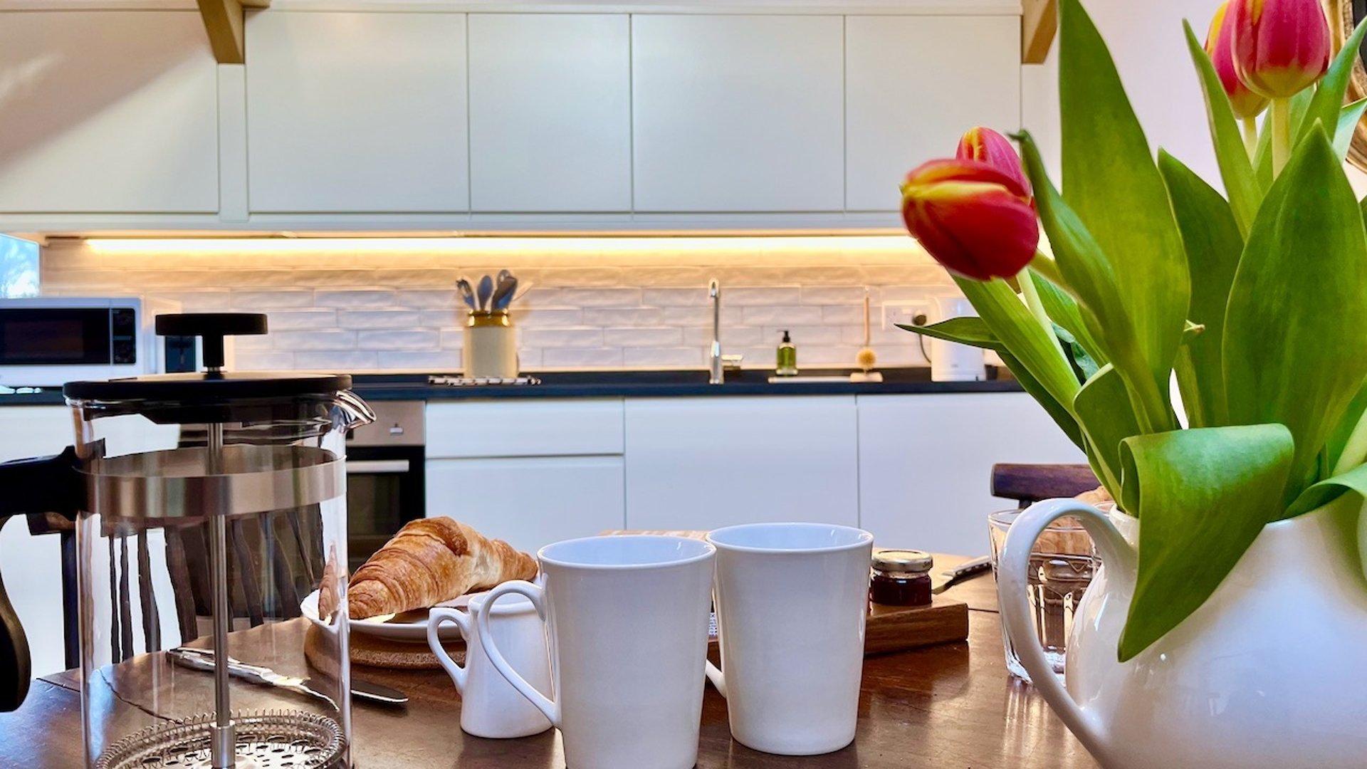 the hayloft kitchen with a table and flowers