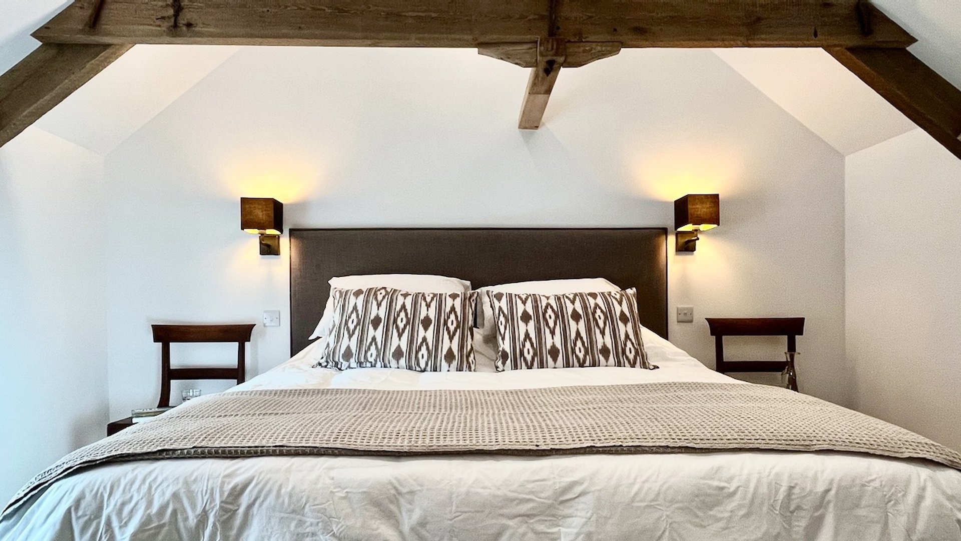 stylish bedroom with muted colours and beams above