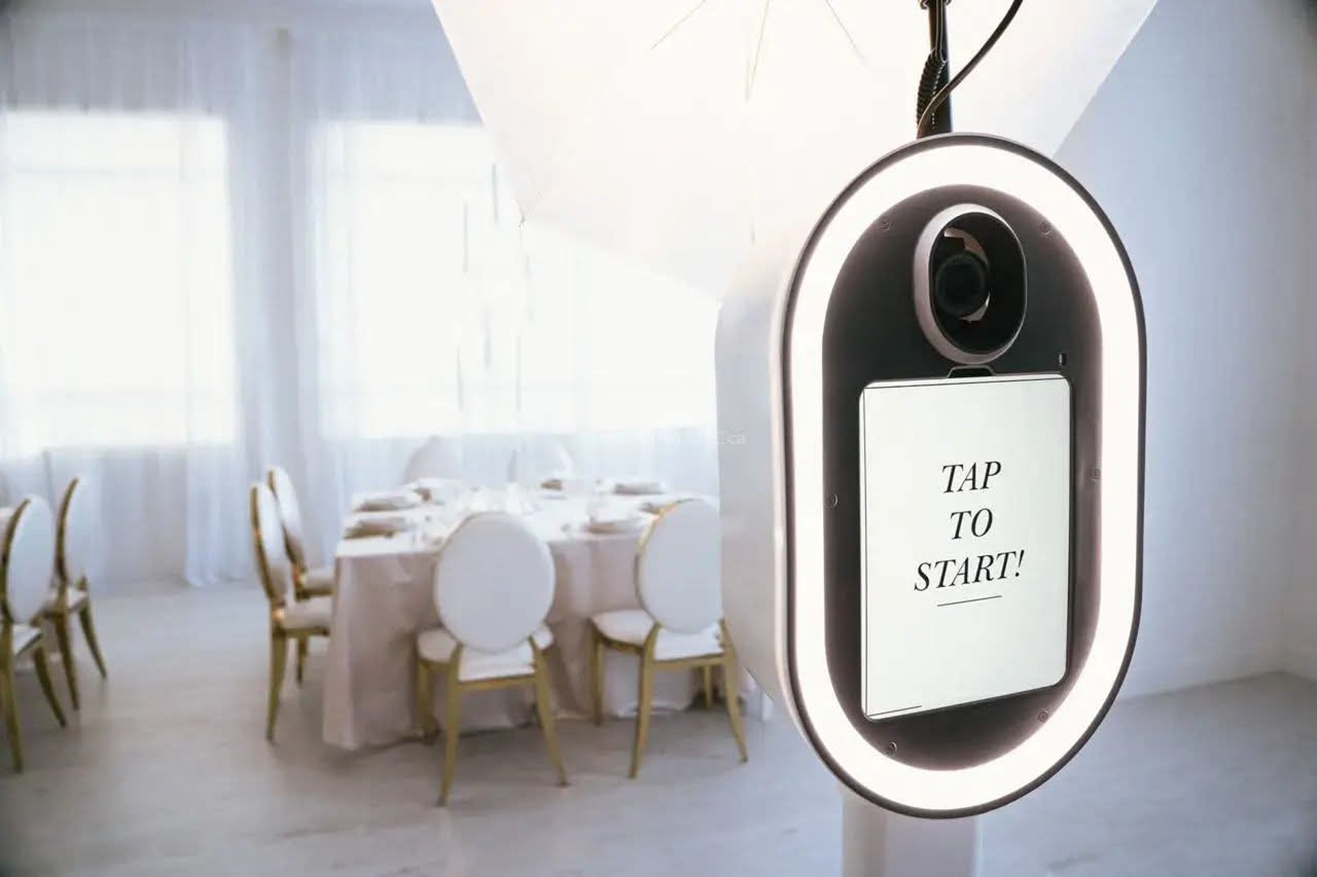 Friends pose happily in a photo booth with props.