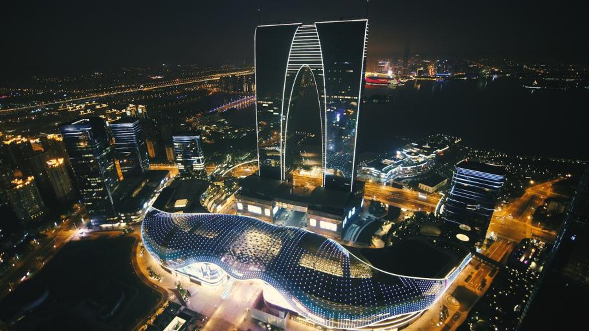 an abstract photo of a curved building with a blue sky in the background