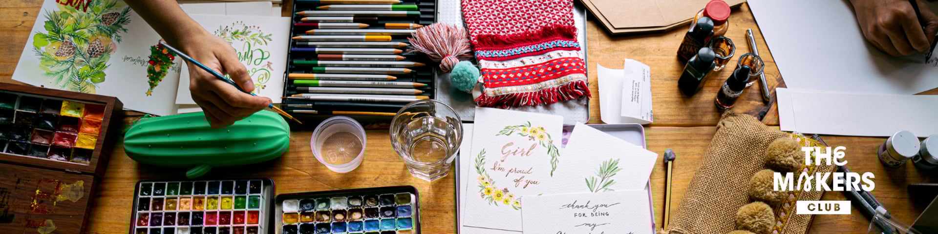 two young girls sitting at a table with markers and crayons