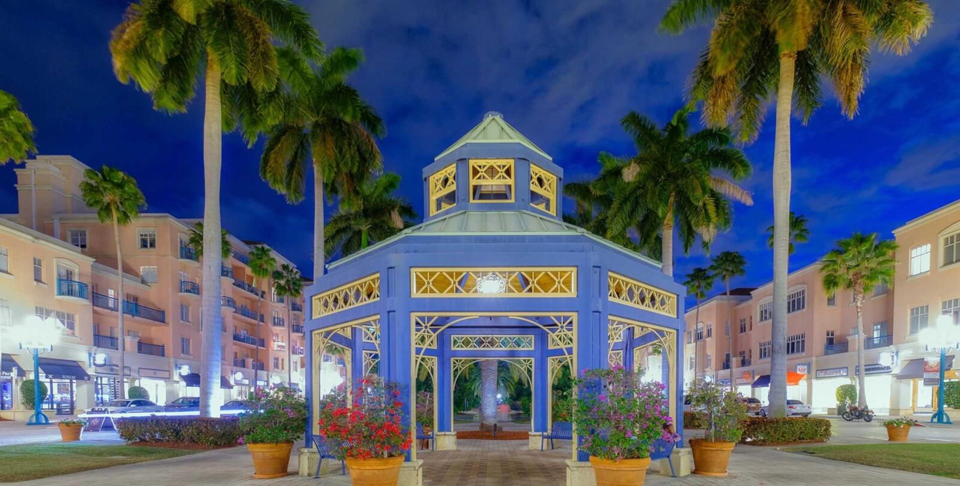 a woman in a blue dress sitting on a fountain