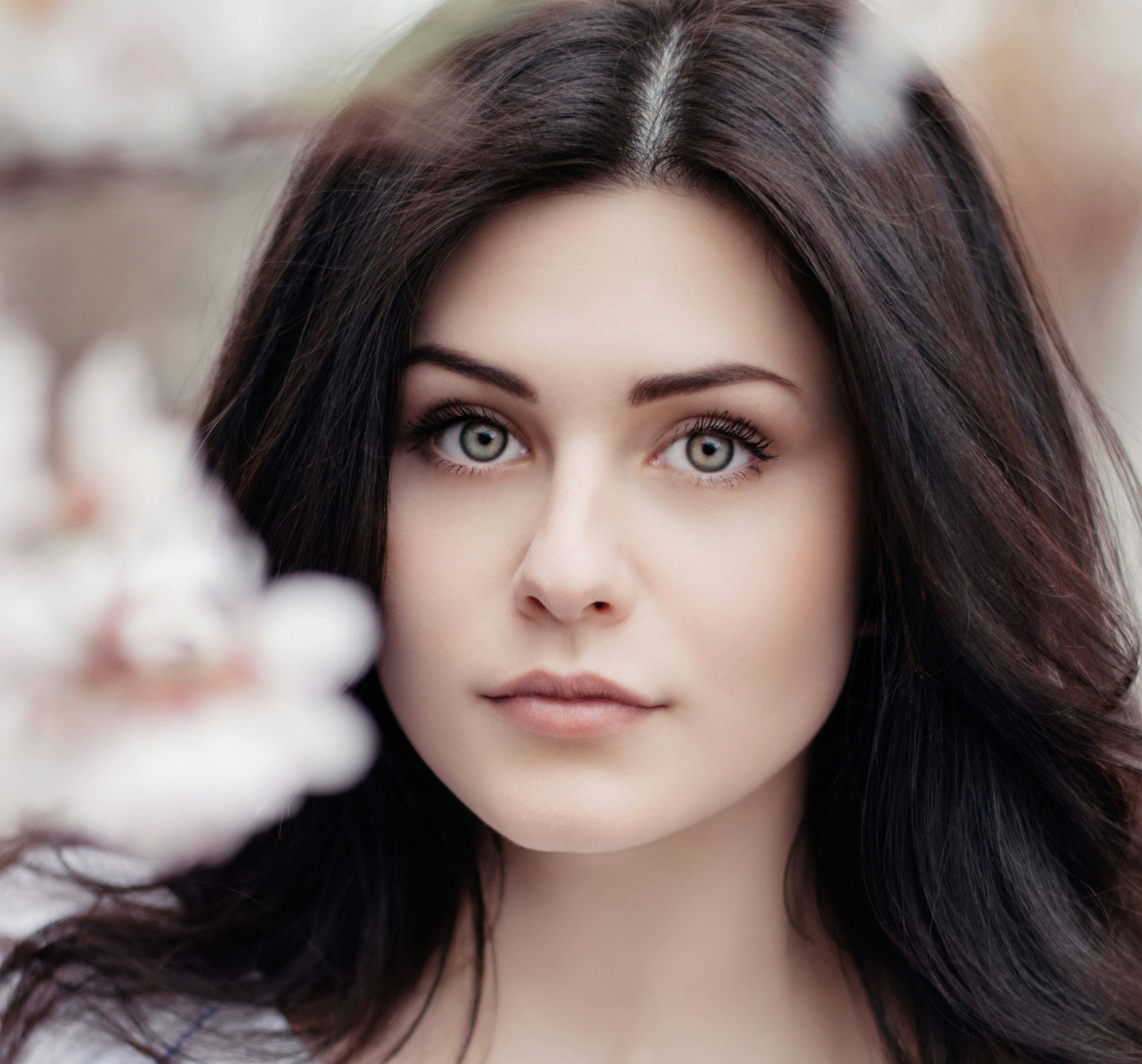 woman standing near white petaled flower
