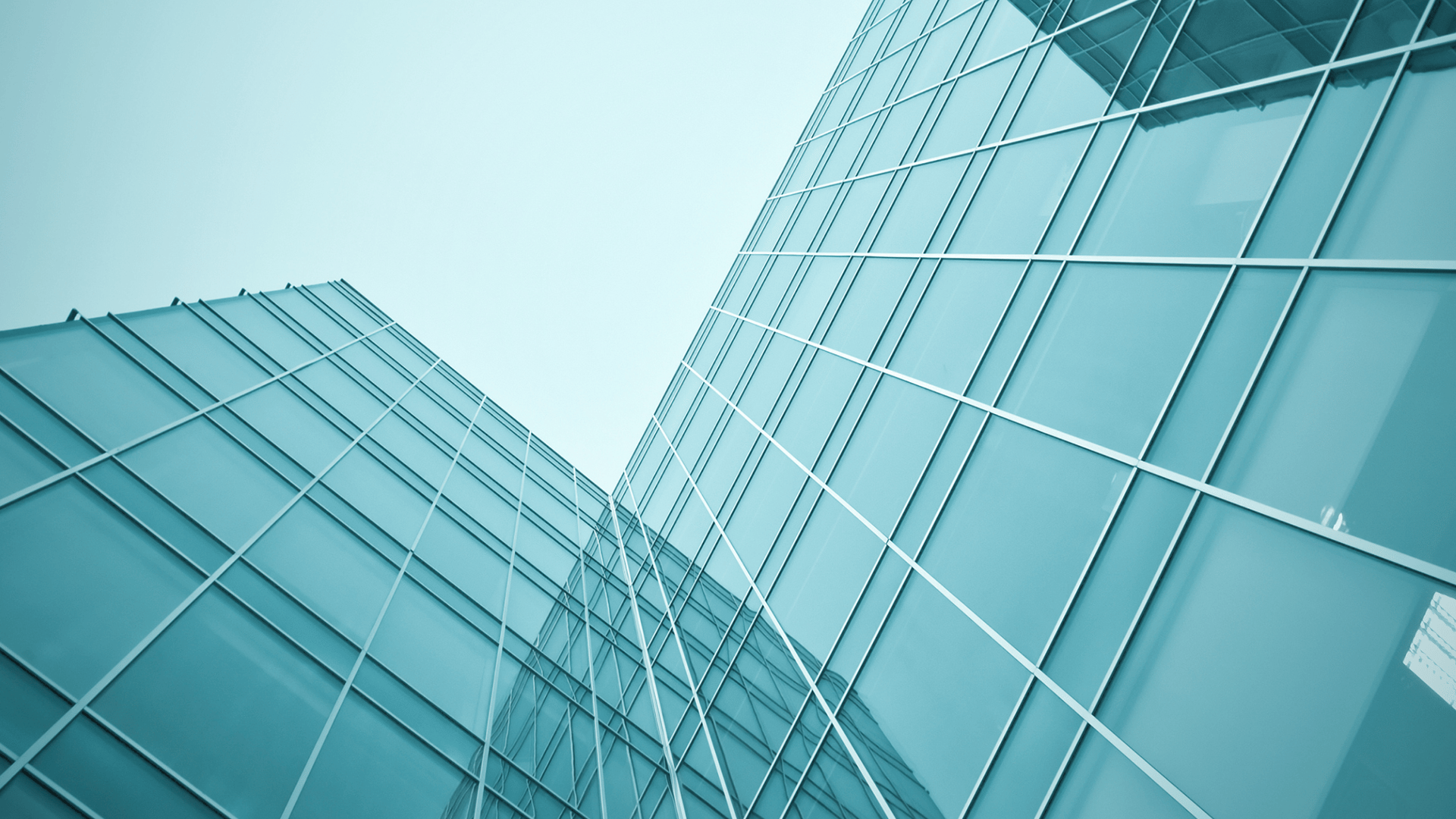 an abstract photo of a curved building with a blue sky in the background