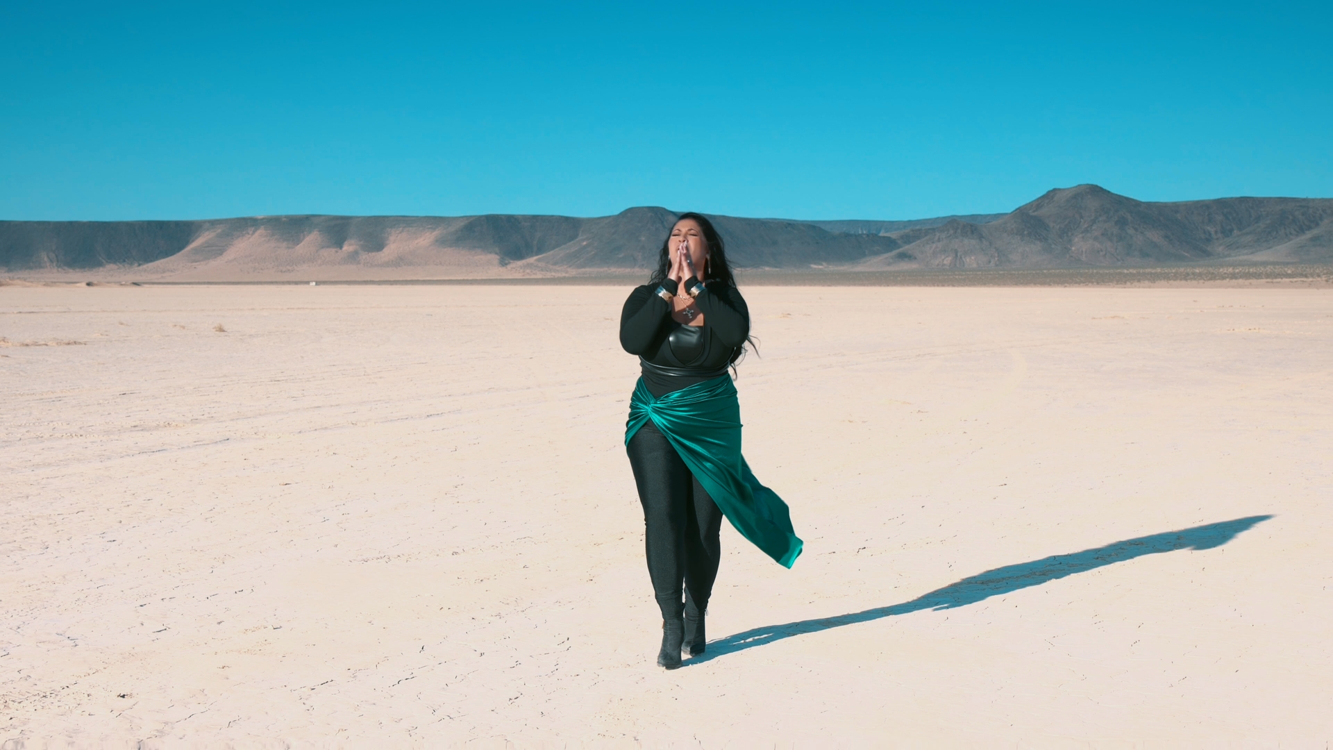 woman wearing yellow long-sleeved dress under white clouds and blue sky during daytime