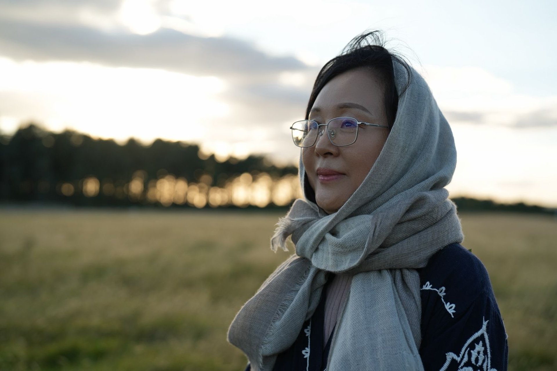 green and brown mountains near body of water under blue sky during daytime