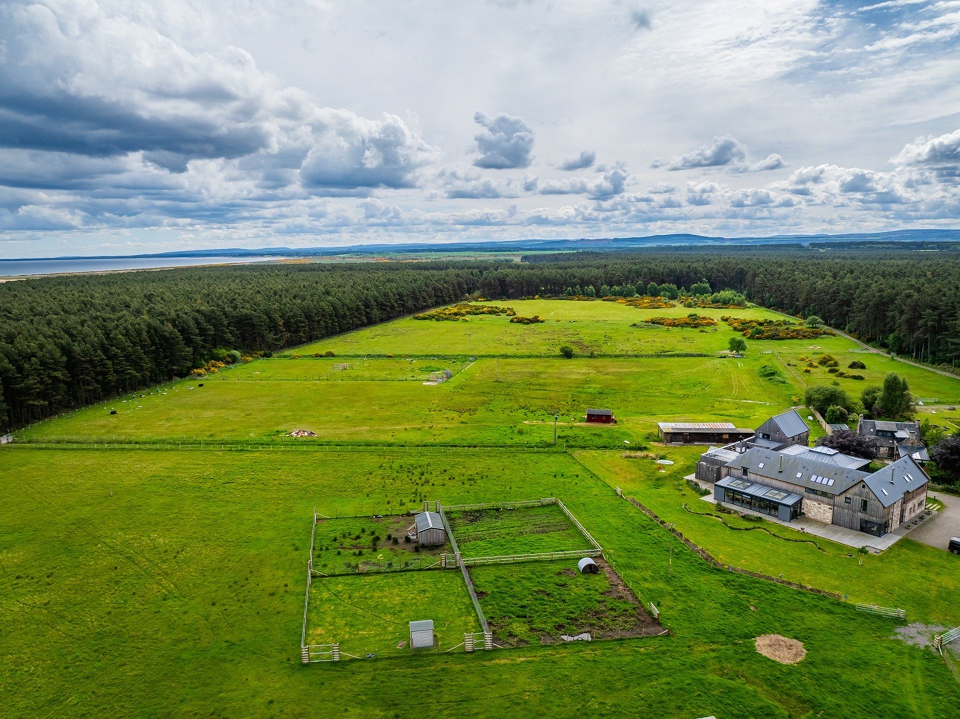 green grass on mountain under white cloudy sky