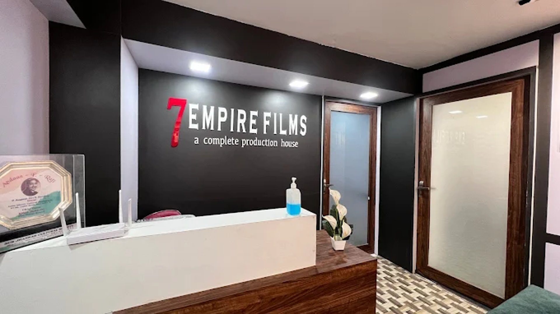 woman in black long sleeve shirt and blue denim jeans sitting on white concrete wall