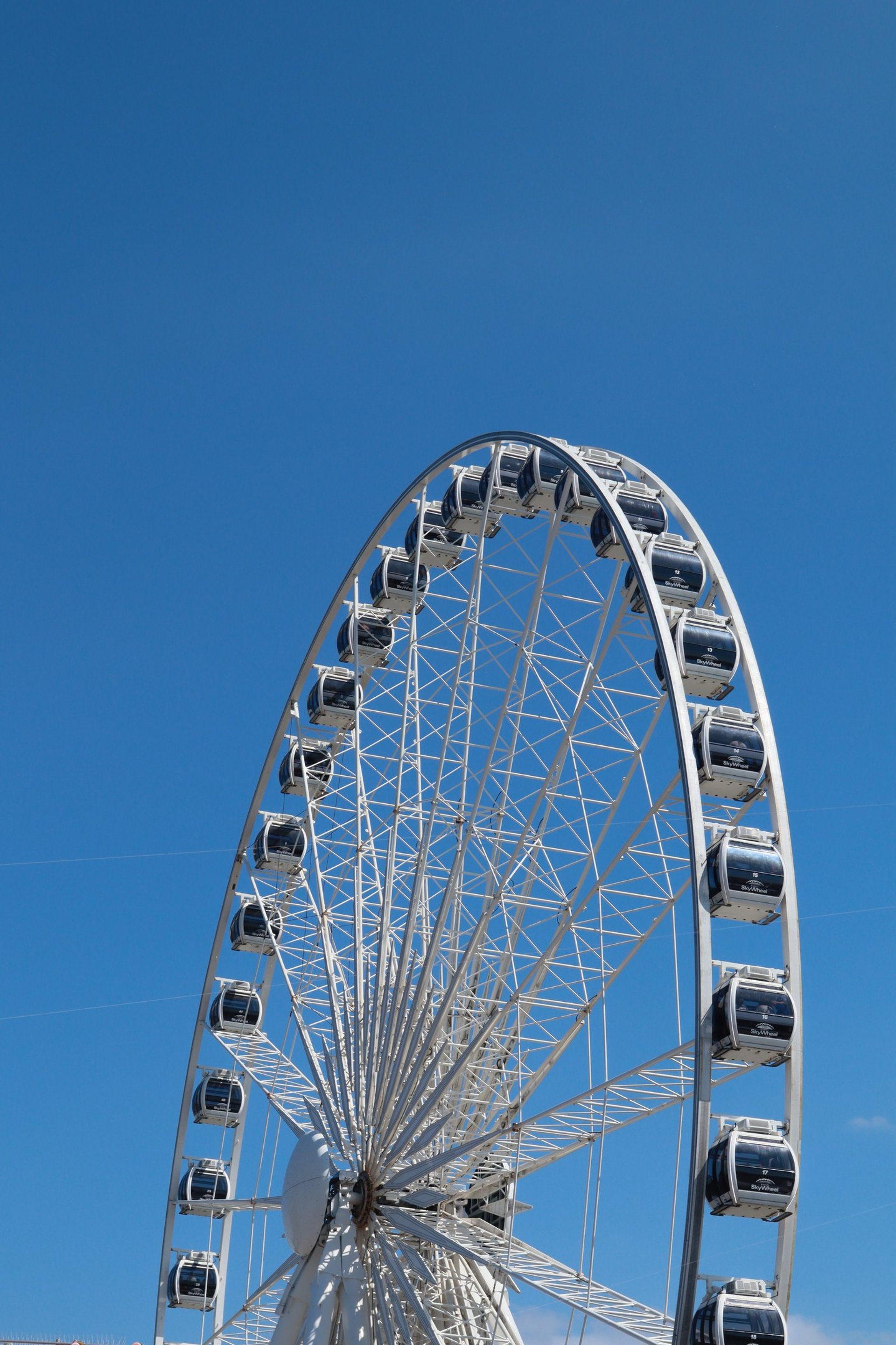 an abstract photo of a curved building with a blue sky in the background
