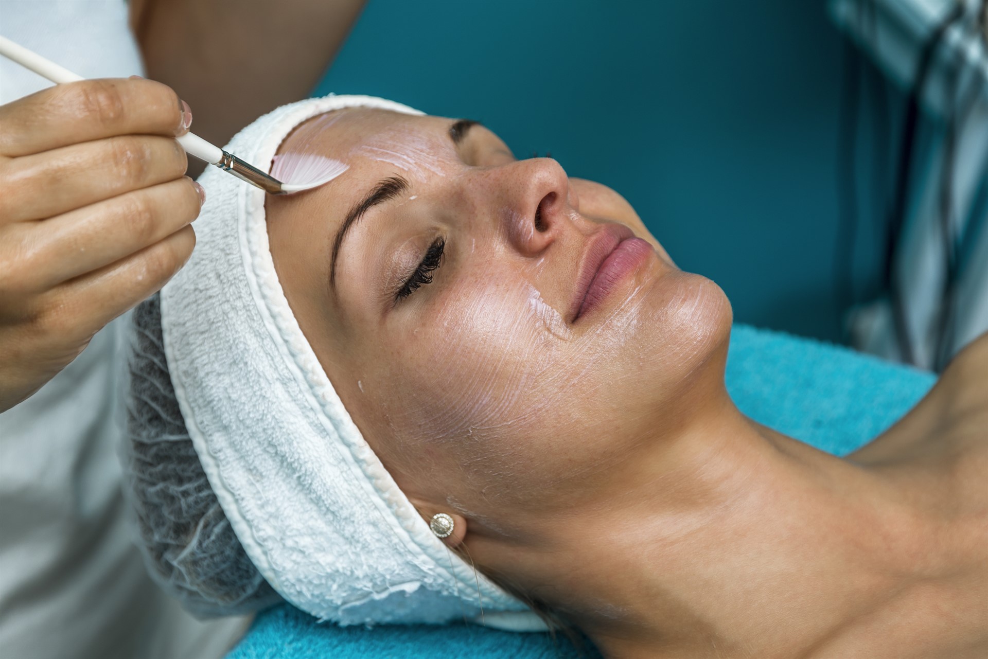 woman doing liposuction on her face