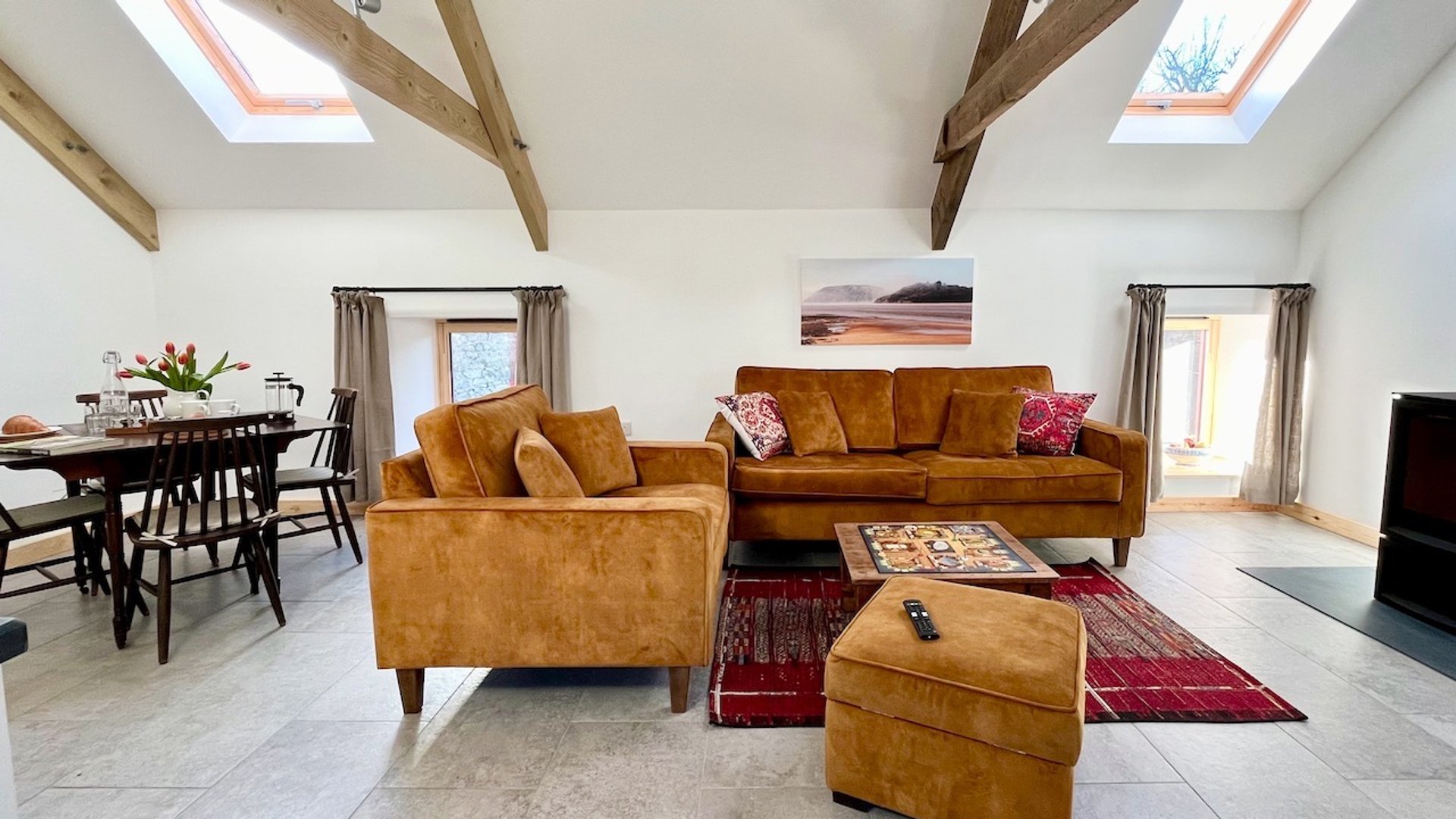 a brightly lit room with ochre coloured seating