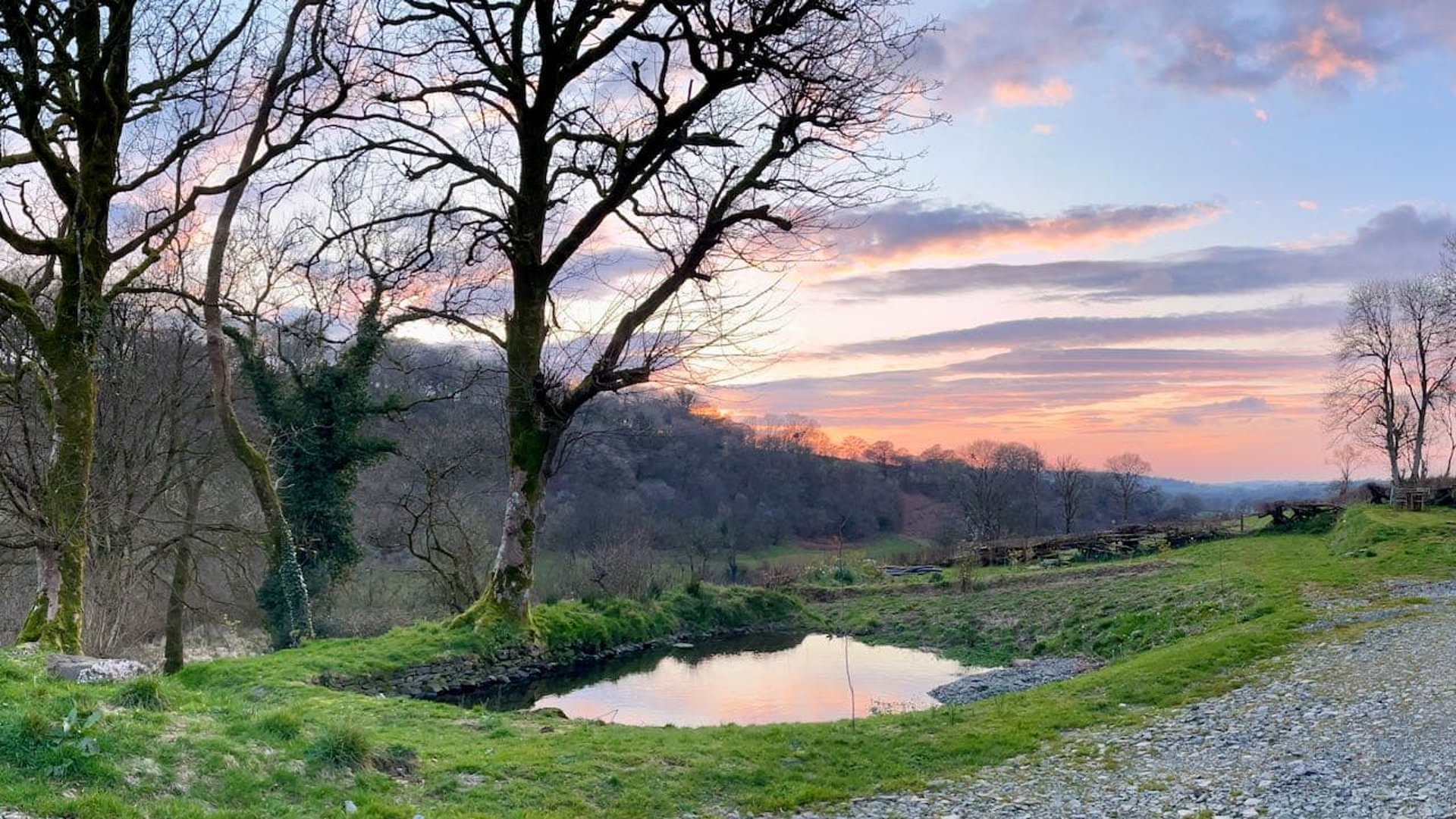 sunset at berllan reflected in the pond