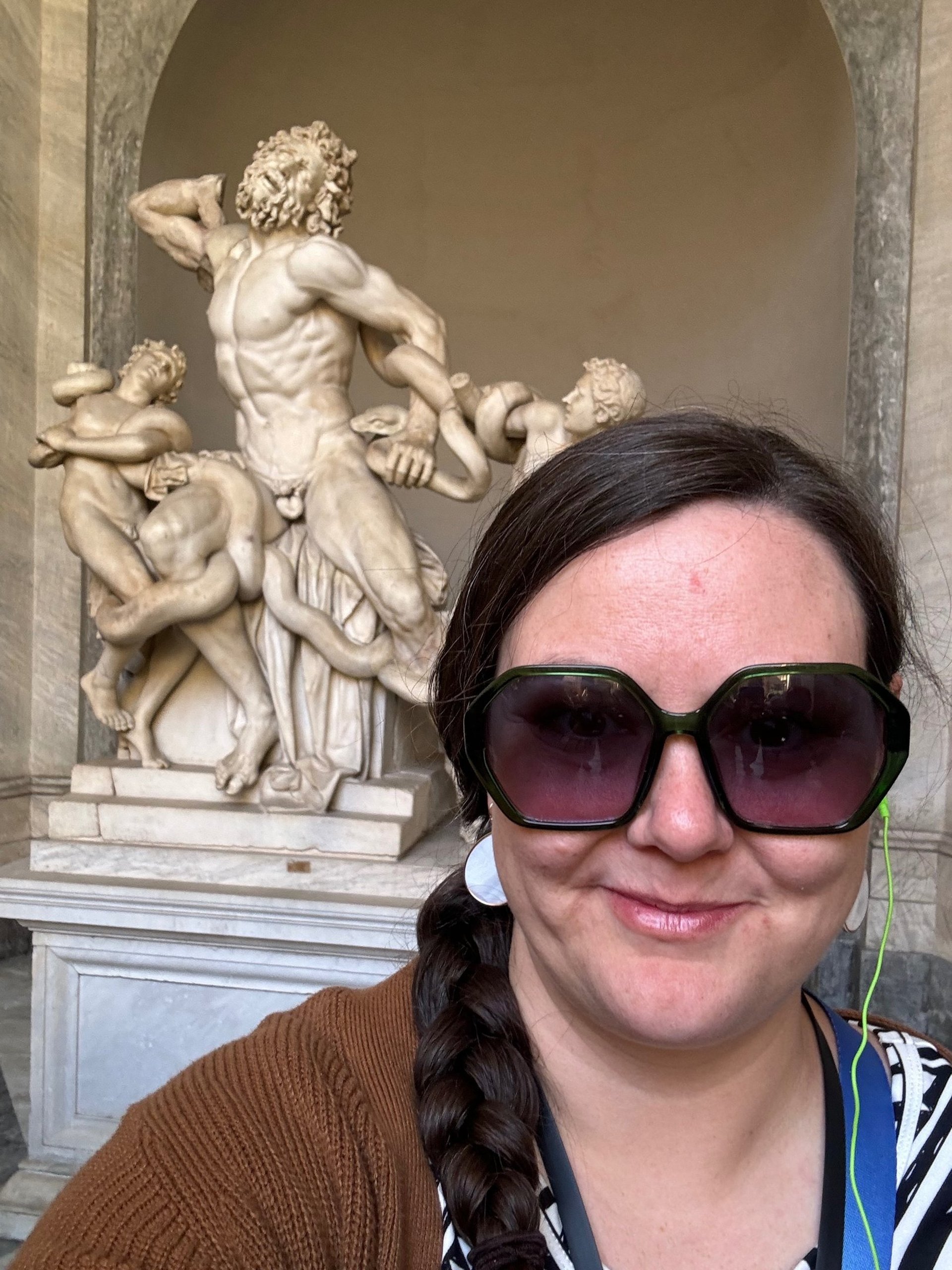 Cassie standing in front of Laocoon, a sculpture in the Vatican