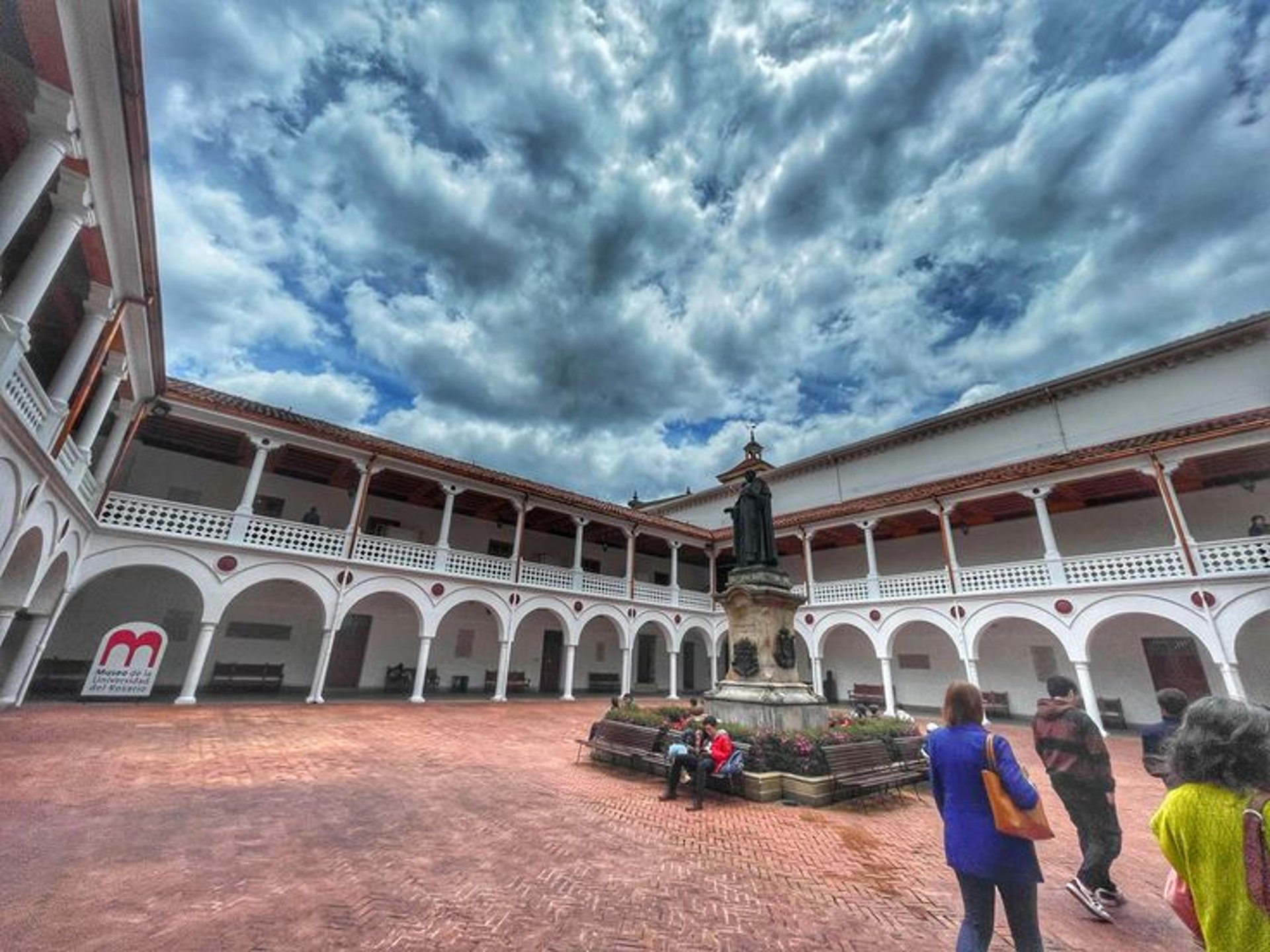 woman wearing yellow long-sleeved dress under white clouds and blue sky during daytime