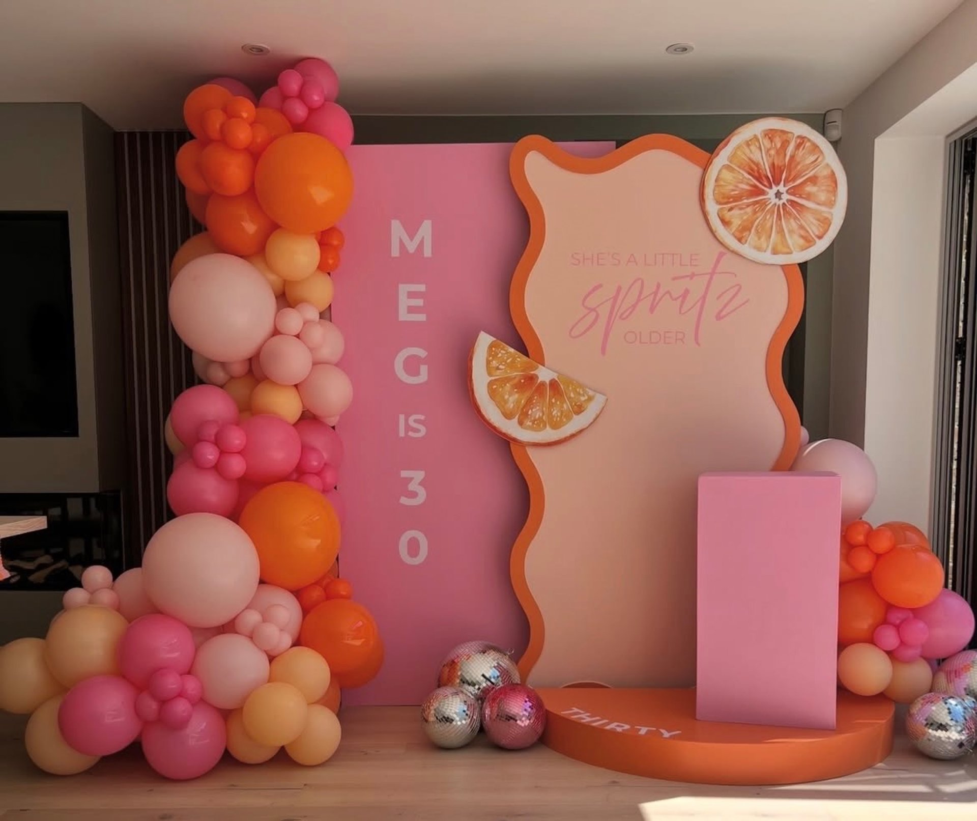 a person painting a pink wall with yellow paint