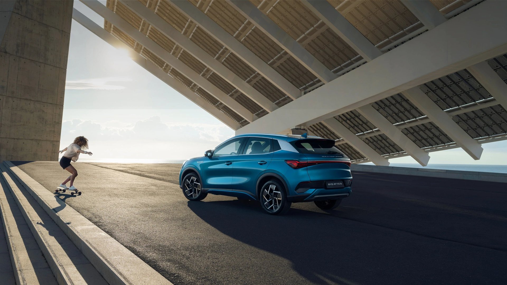 an abstract photo of a curved building with a blue sky in the background