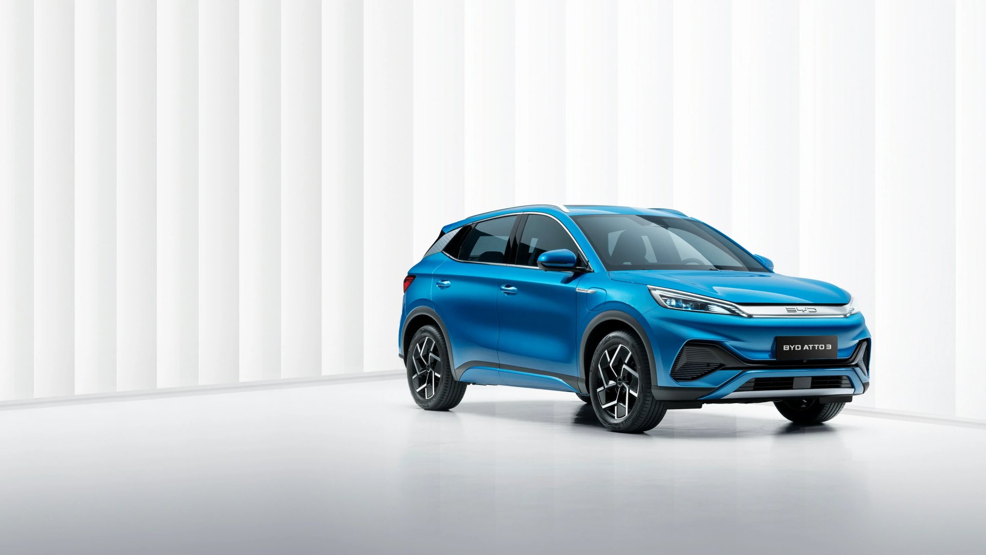 an abstract photo of a curved building with a blue sky in the background