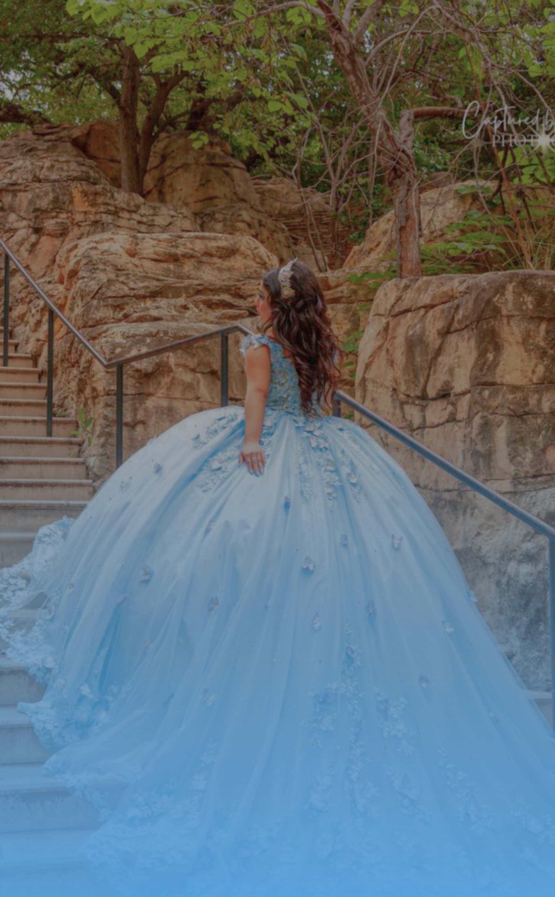 a man and a woman kissing in front of some rocks