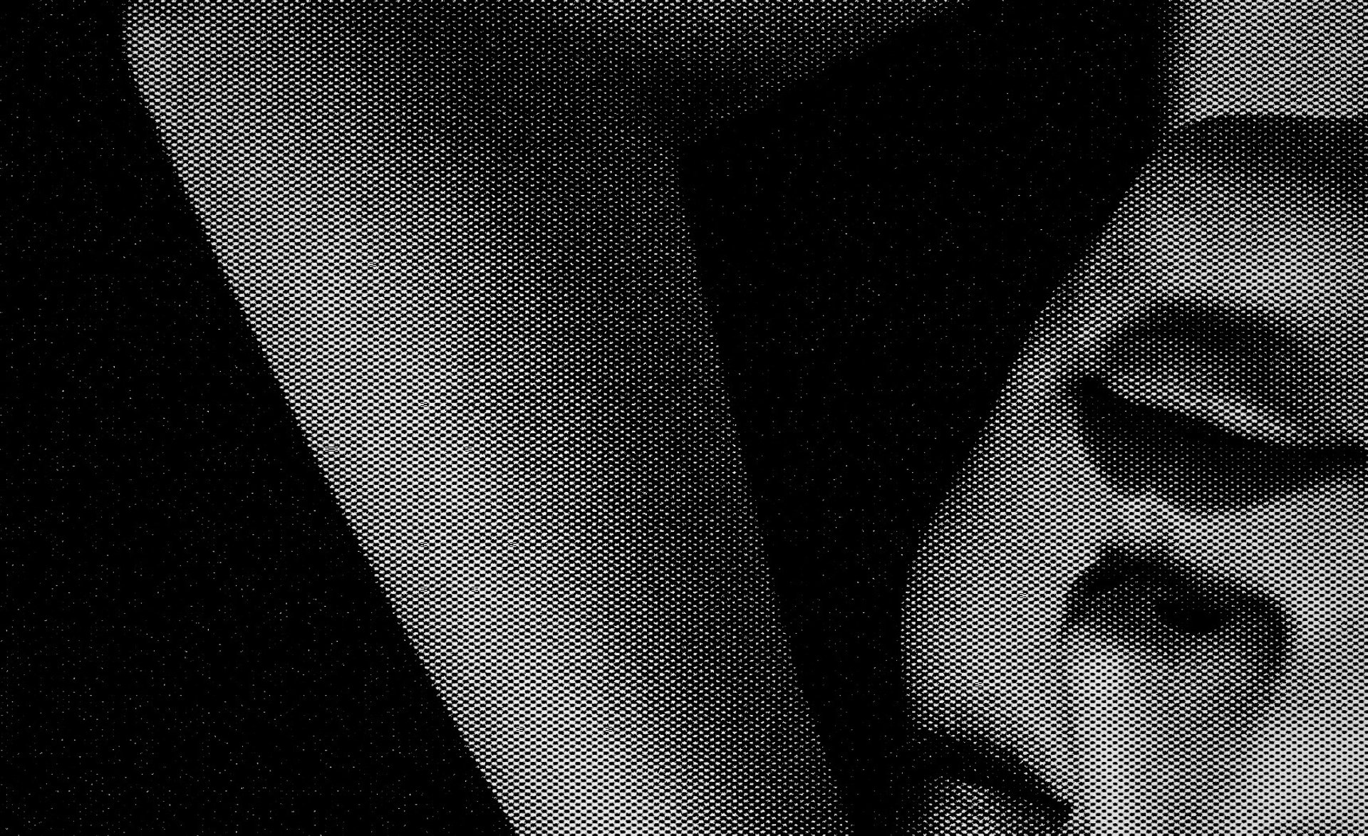 an abstract photo of a curved building with a blue sky in the background