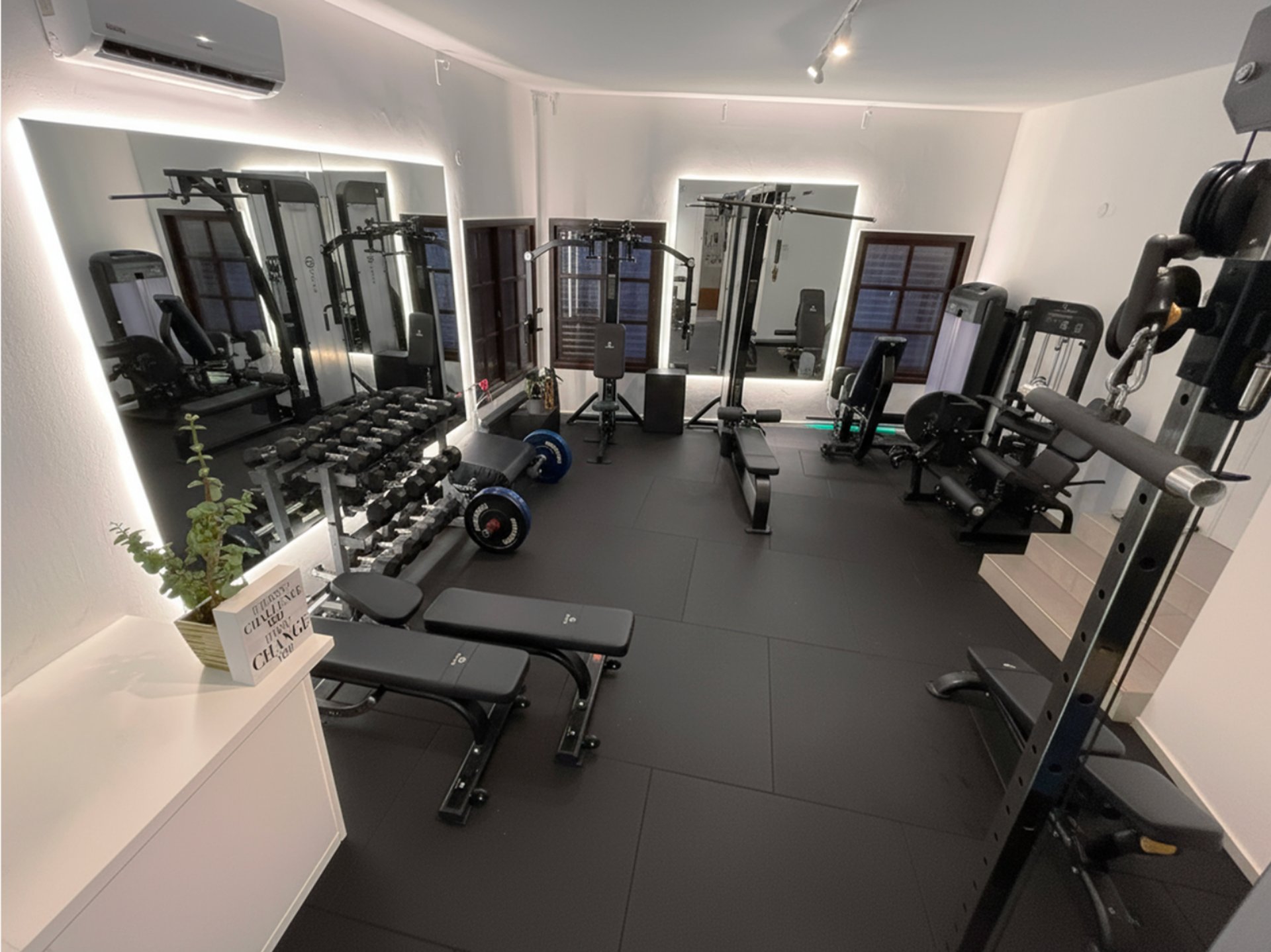 woman standing surrounded by exercise equipment