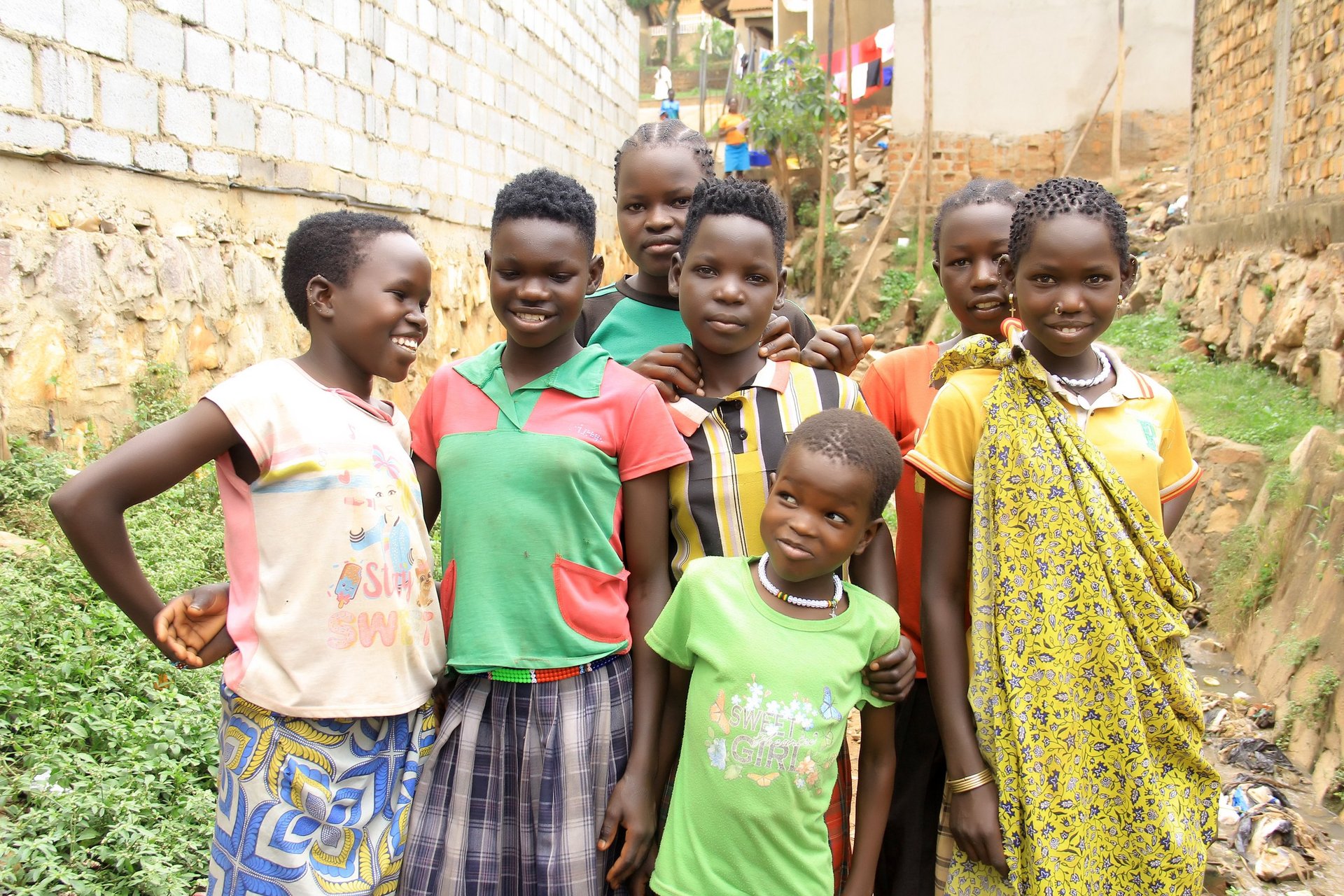 Group of Karamojong children smiling outside Katwe suburb in Kampala.