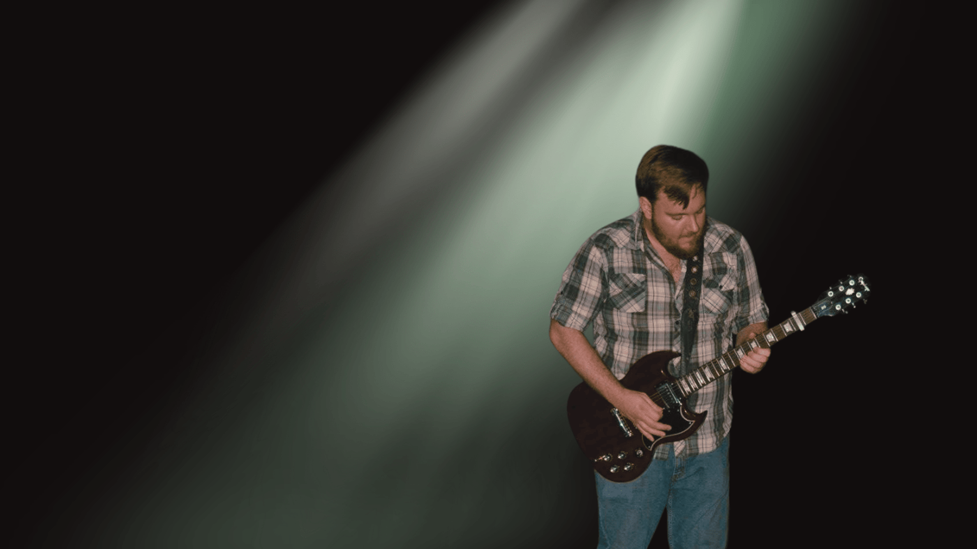 John playing guitar with Black background and green light leaks
