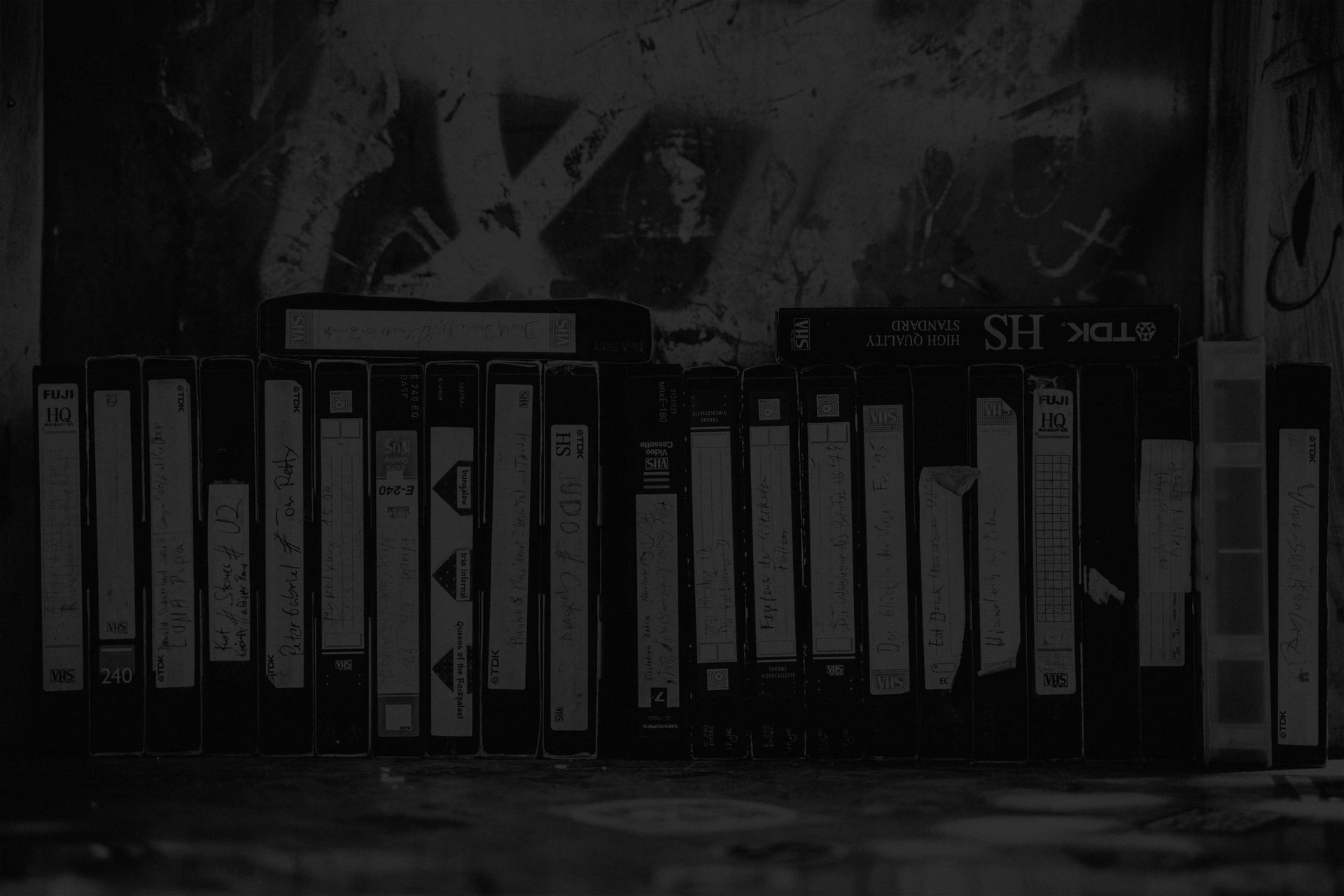 a row of video tapes arranged haphazardly 