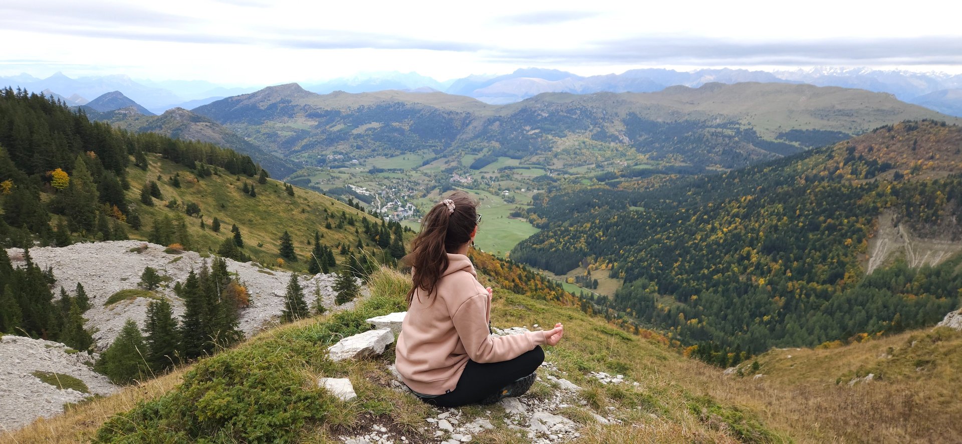 woman sitting on bench over viewing mountain