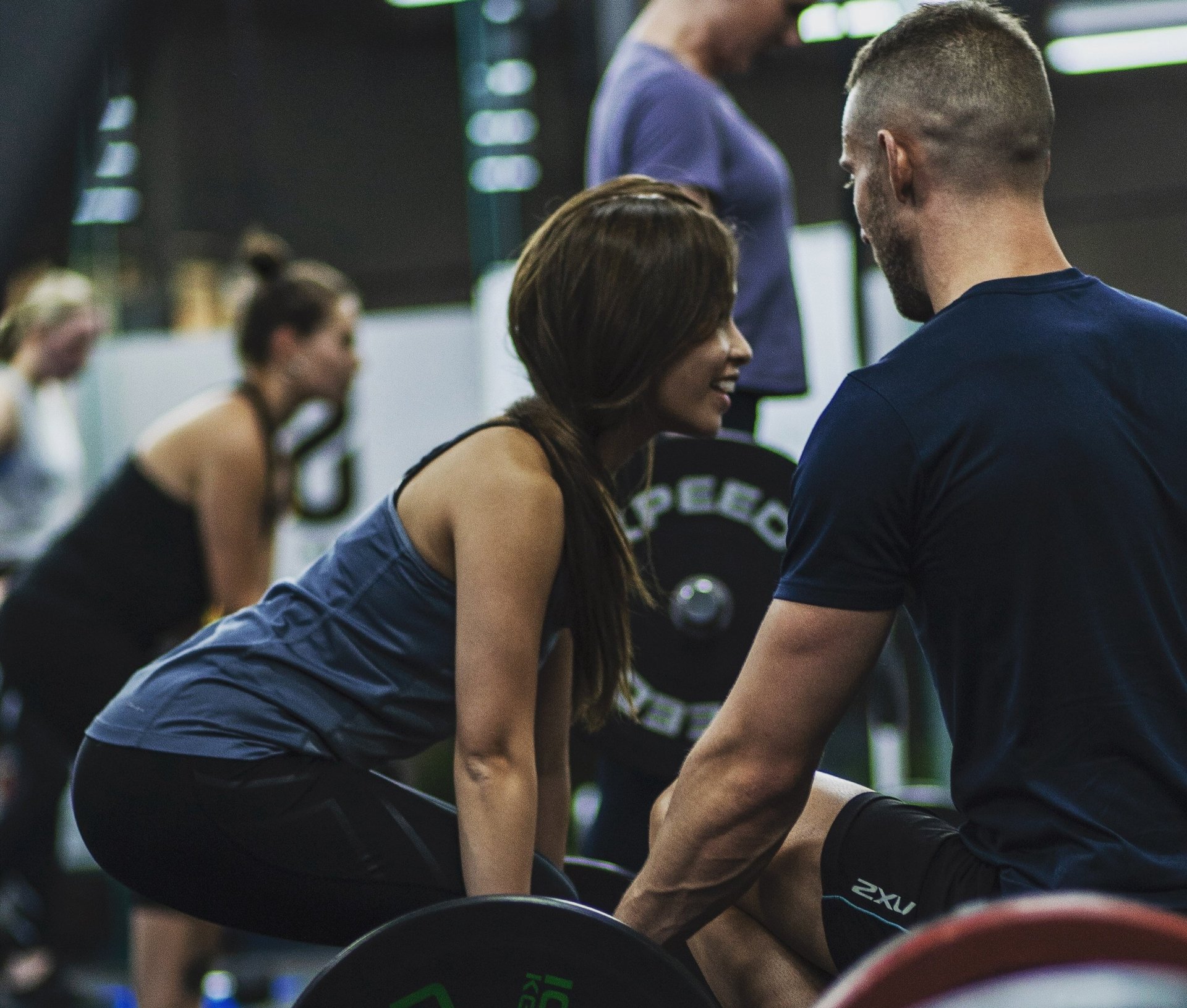 topless man in black shorts sitting on black and silver barbell