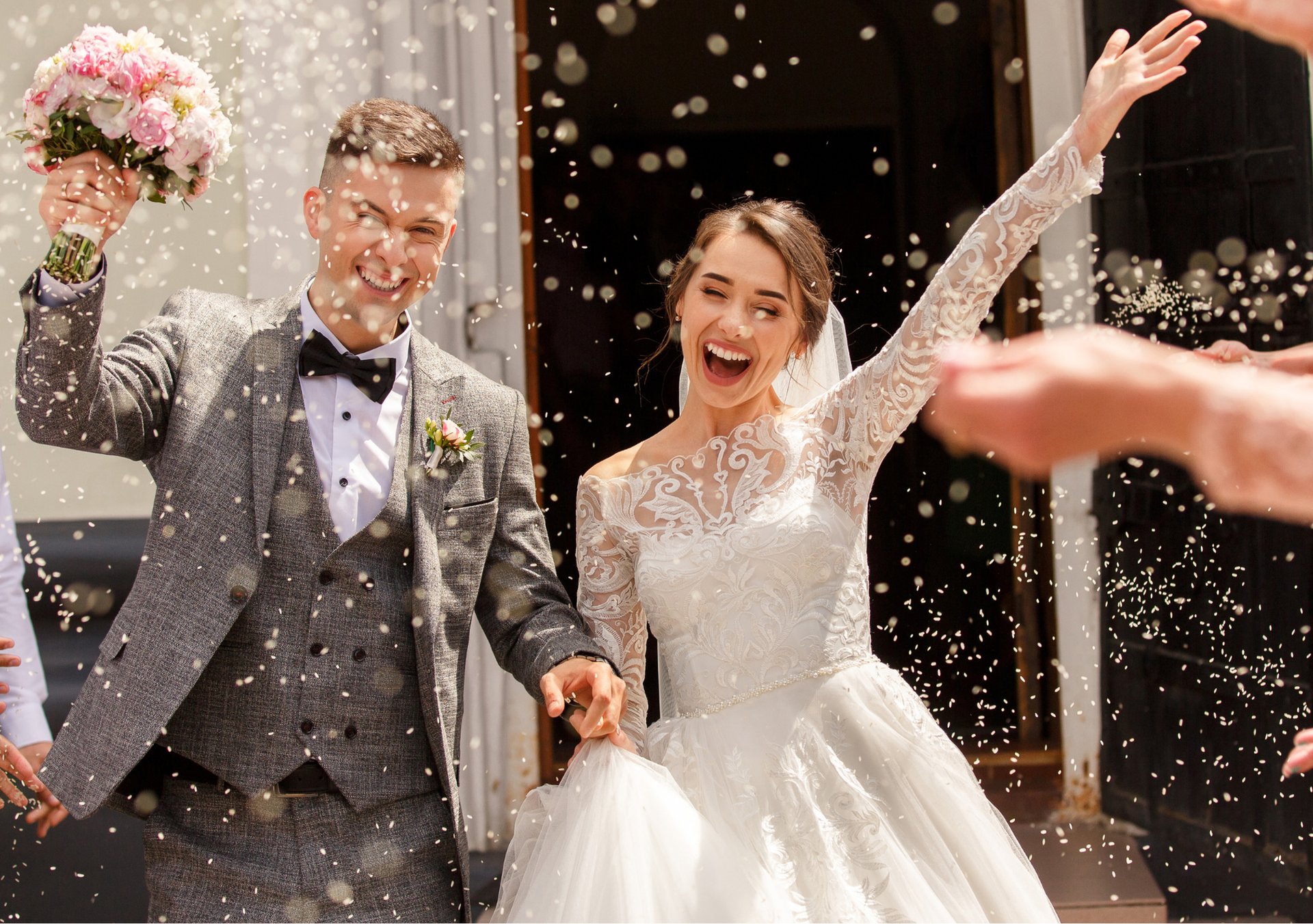 man and woman in wedding dress walking on brown grass field during daytime