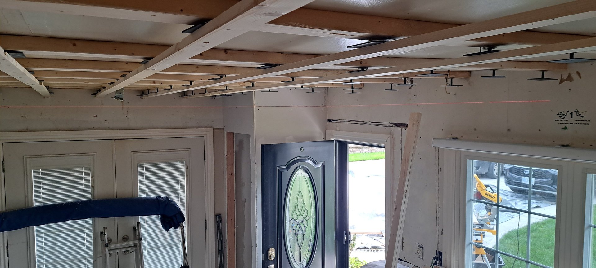 Wood ceiling framing installation in progress for residential levelling renovation project in Canada