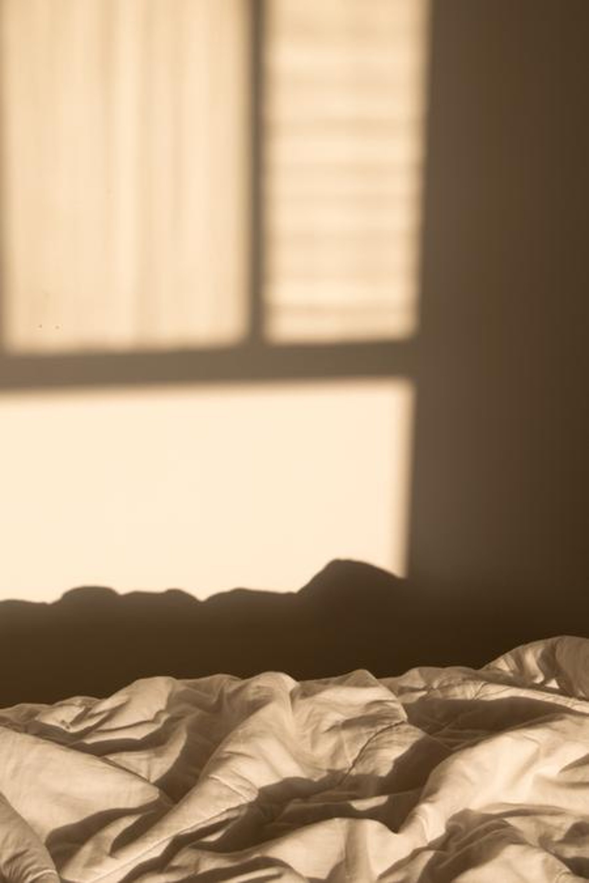 an abstract photo of a curved building with a blue sky in the background