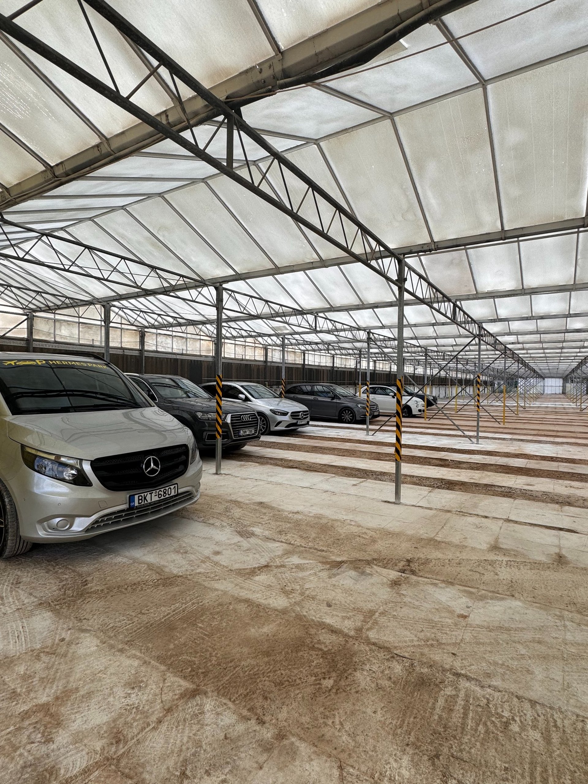 Cars parked with airplane in background