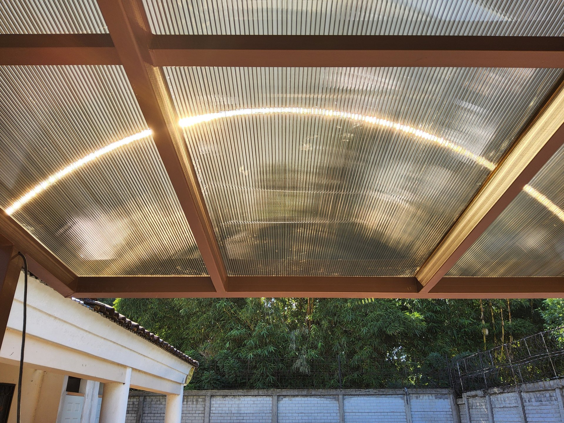an abstract photo of a curved building with a blue sky in the background