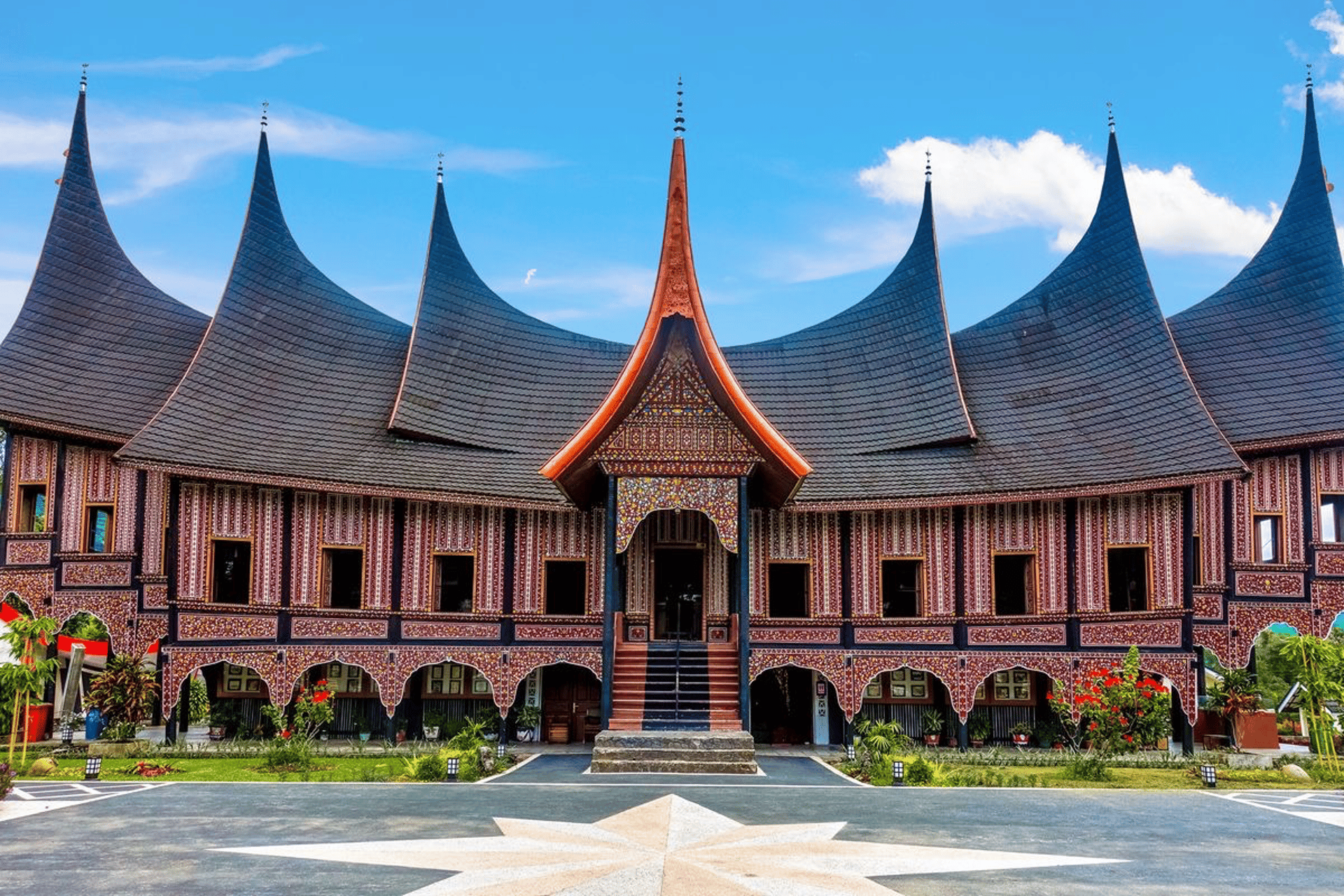 a building with a red roof and a white fence