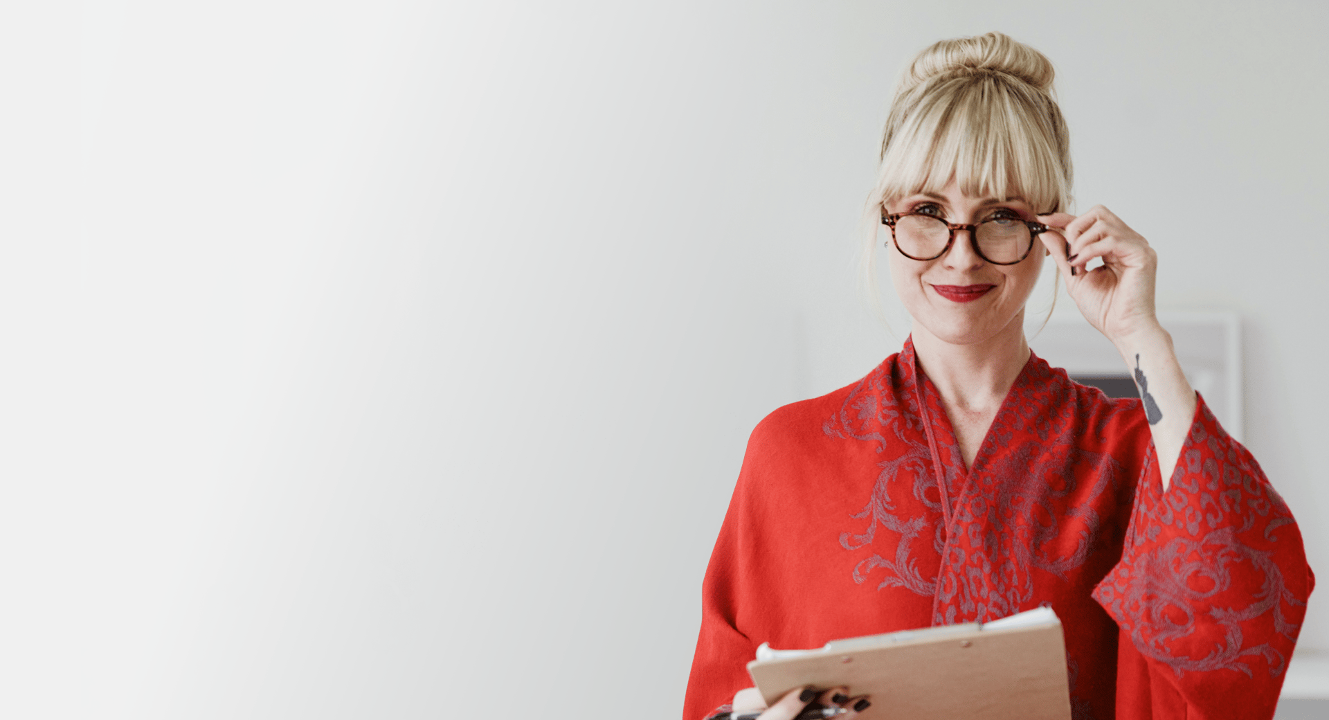 woman in red cardigan smiling