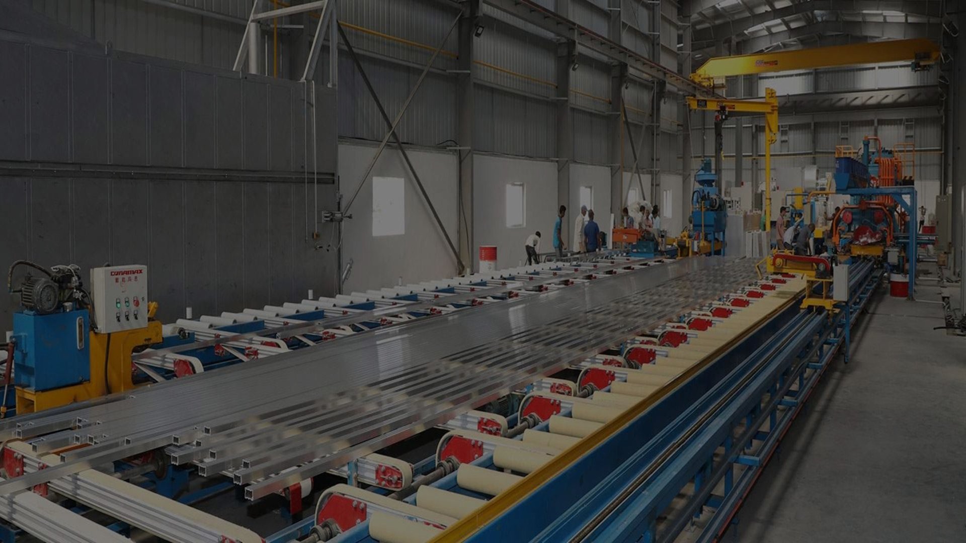 A man in a factory working on a piece of machinery