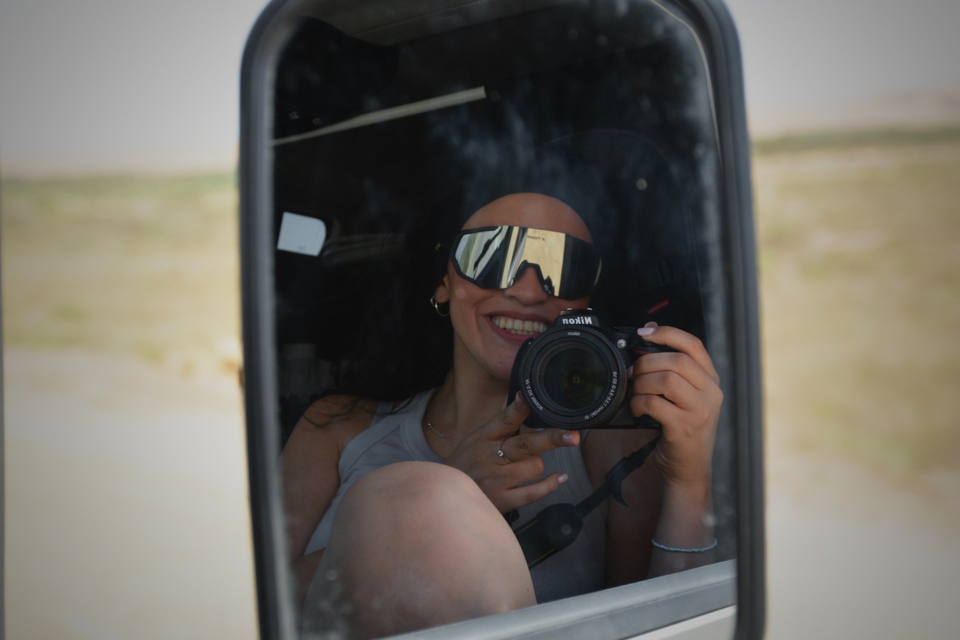 woman wearing yellow long-sleeved dress under white clouds and blue sky during daytime