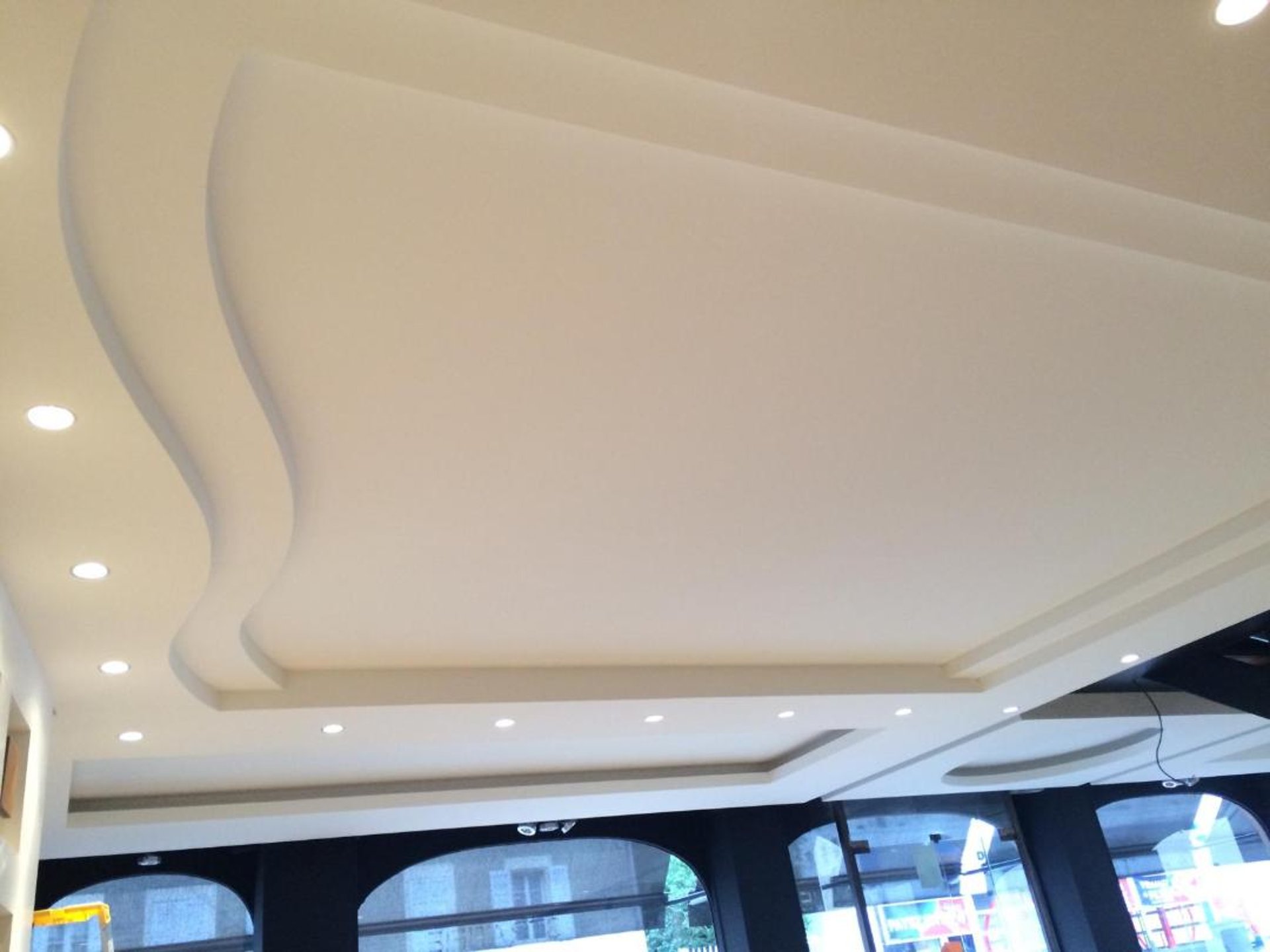 an abstract photo of a curved building with a blue sky in the background